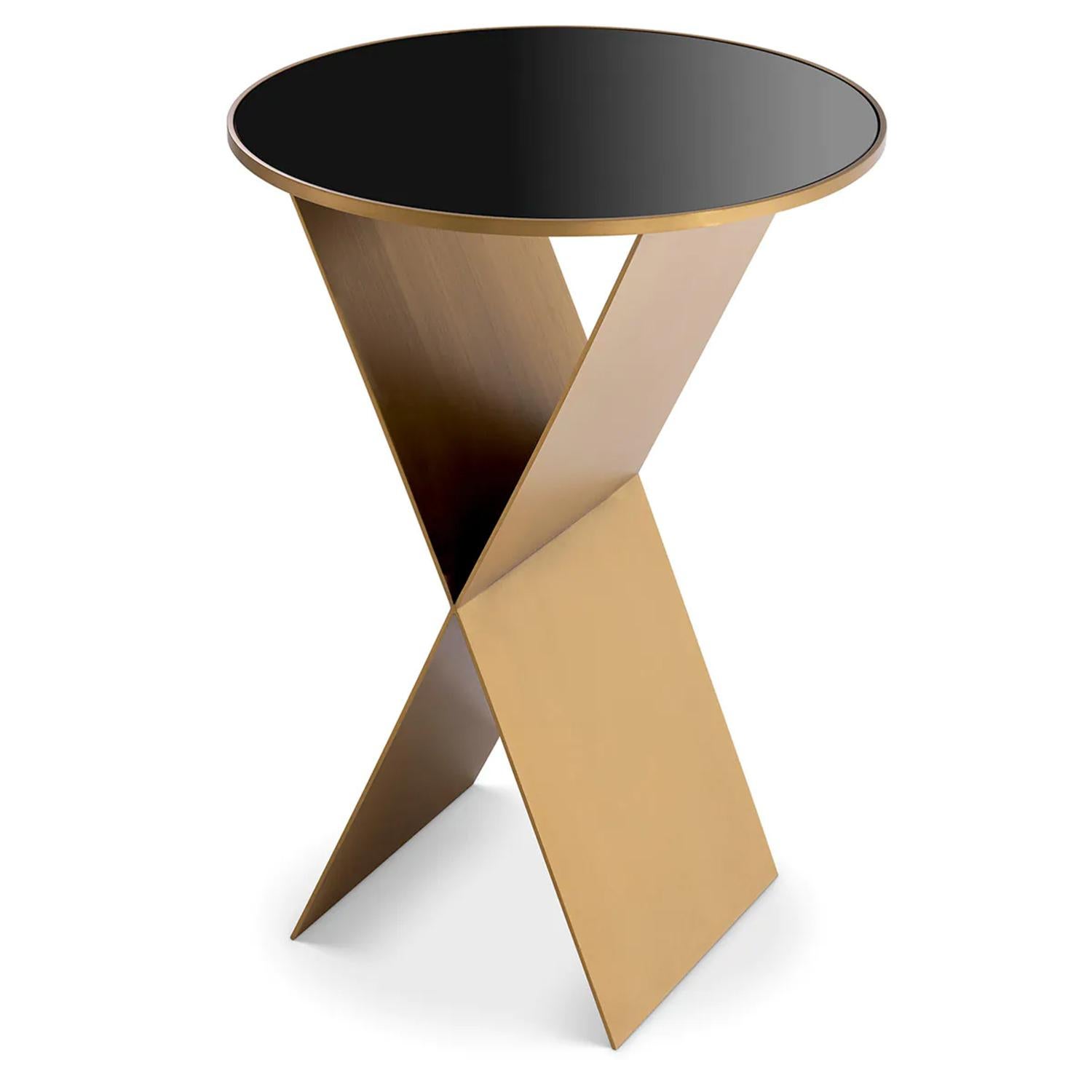 Table d'appoint Tania High avec toute la structure en acier inoxydable en 
finition laiton brossé. et avec un plateau rond en verre noir.
Également disponible sur demande en Ø50xH50cm.
