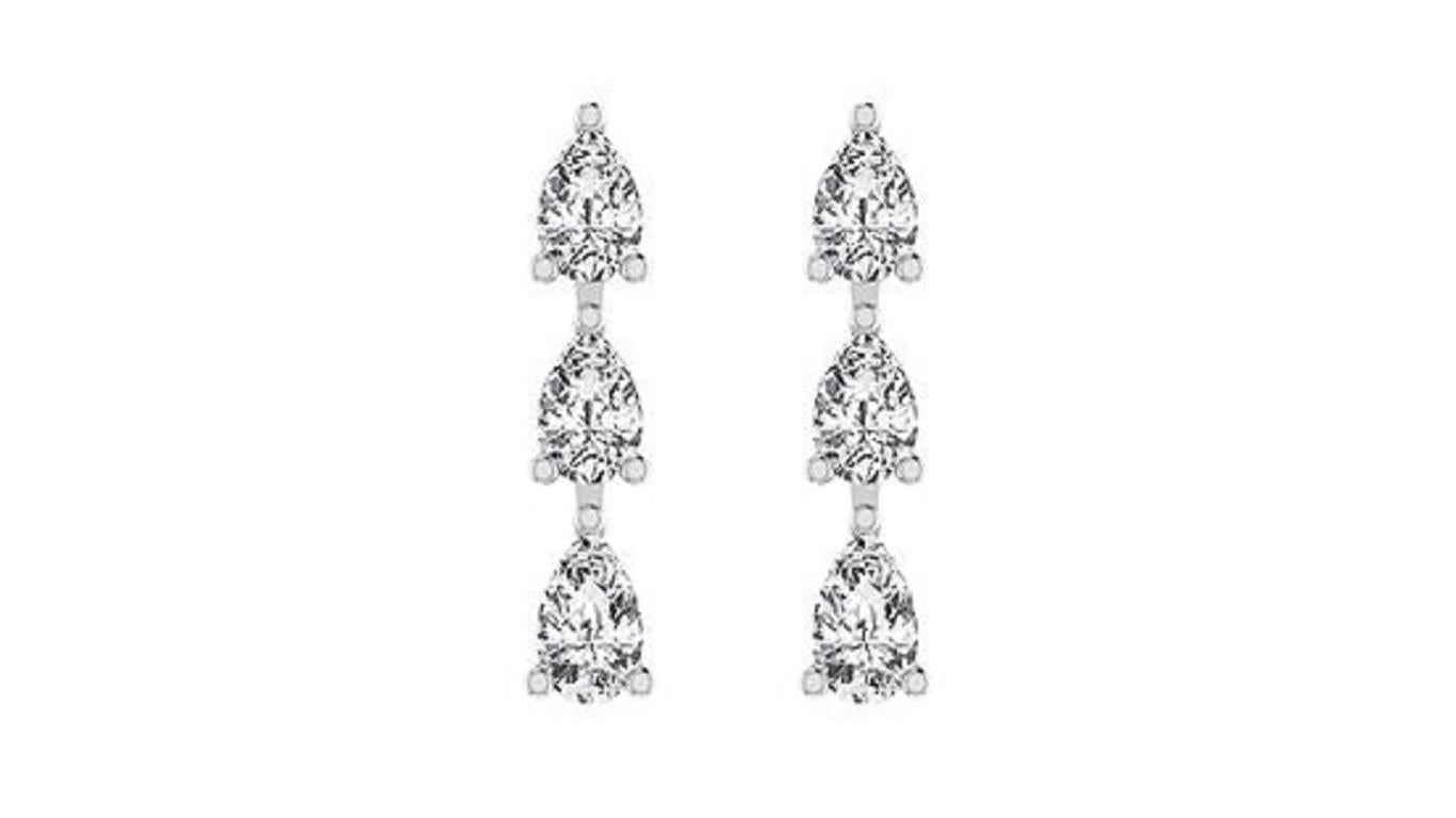 Gli orecchini con diamanti a goccia a tre pere in oro 18 carati emanano eleganza e raffinatezza. Ogni orecchino presenta tre splendidi diamanti a forma di pera che scendono a cascata in un grazioso design a goccia, accentuato dal caldo bagliore