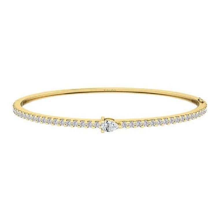 The Pear Diamond Bangle in 18K gold features a sleek design adorned with pear-shaped diamonds, creating a sophisticated and timeless piece. Elegant and understated, this bangle adds a perfect touch of sparkle to any ensemble.

Pear Diamond Bangle in