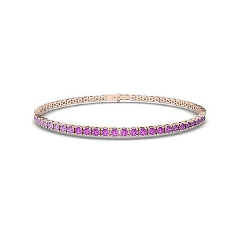 The Ombre Pink Sapphire Tennis Bracelet in 18K gold showcases a mesmerizing gradient of blue sapphires, seamlessly transitioning from deep navy to light azure. Set in a sleek, continuous line, this bracelet brings vibrant color and elegance to any