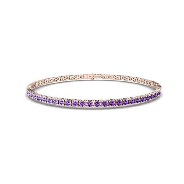 The Ombre Purple Sapphire Tennis Bracelet in 18K gold showcases a mesmerizing gradient of blue sapphires, seamlessly transitioning from deep navy to light azure. Set in a sleek, continuous line, this bracelet brings vibrant color and elegance to any