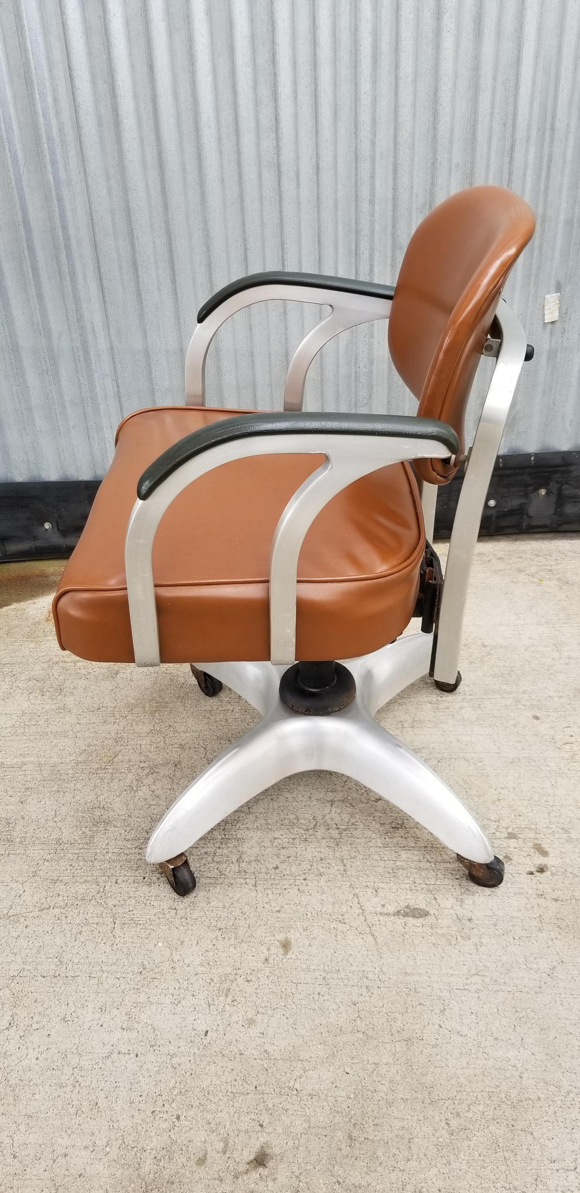Fantastic aluminum industrial modern swivel desk chair by GoodForm. Steel and aluminum construction with original vinyl upholstery. Very good original vintage condition. Seat height is adjustable.