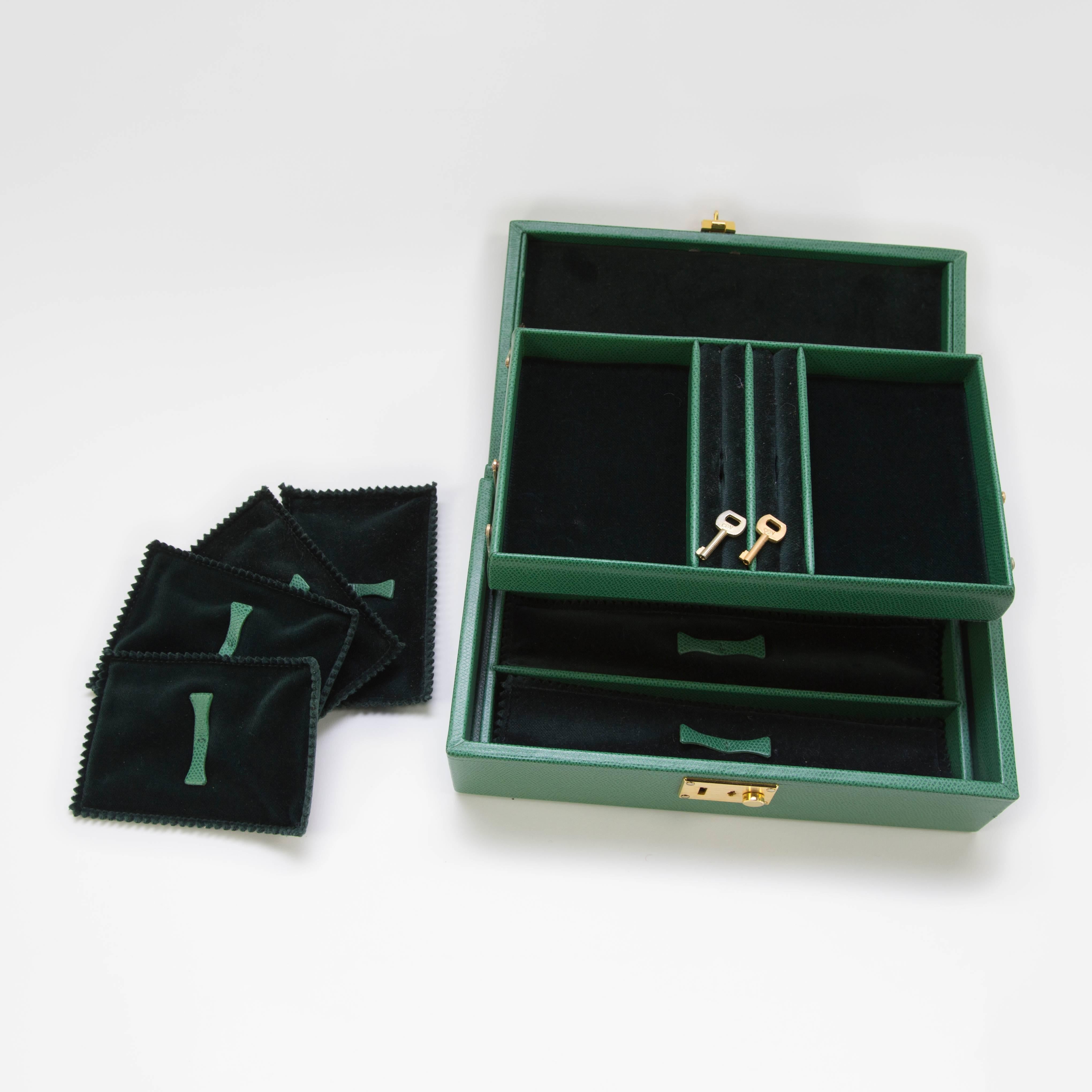 Curating luxury with Tanner Krolle green leather jewelry box, a perfect size for travel! The three separate compartments are fitted with dark green velvet linings and protectors. Never used. Fitted with lock and key. An exceptional gift for that
