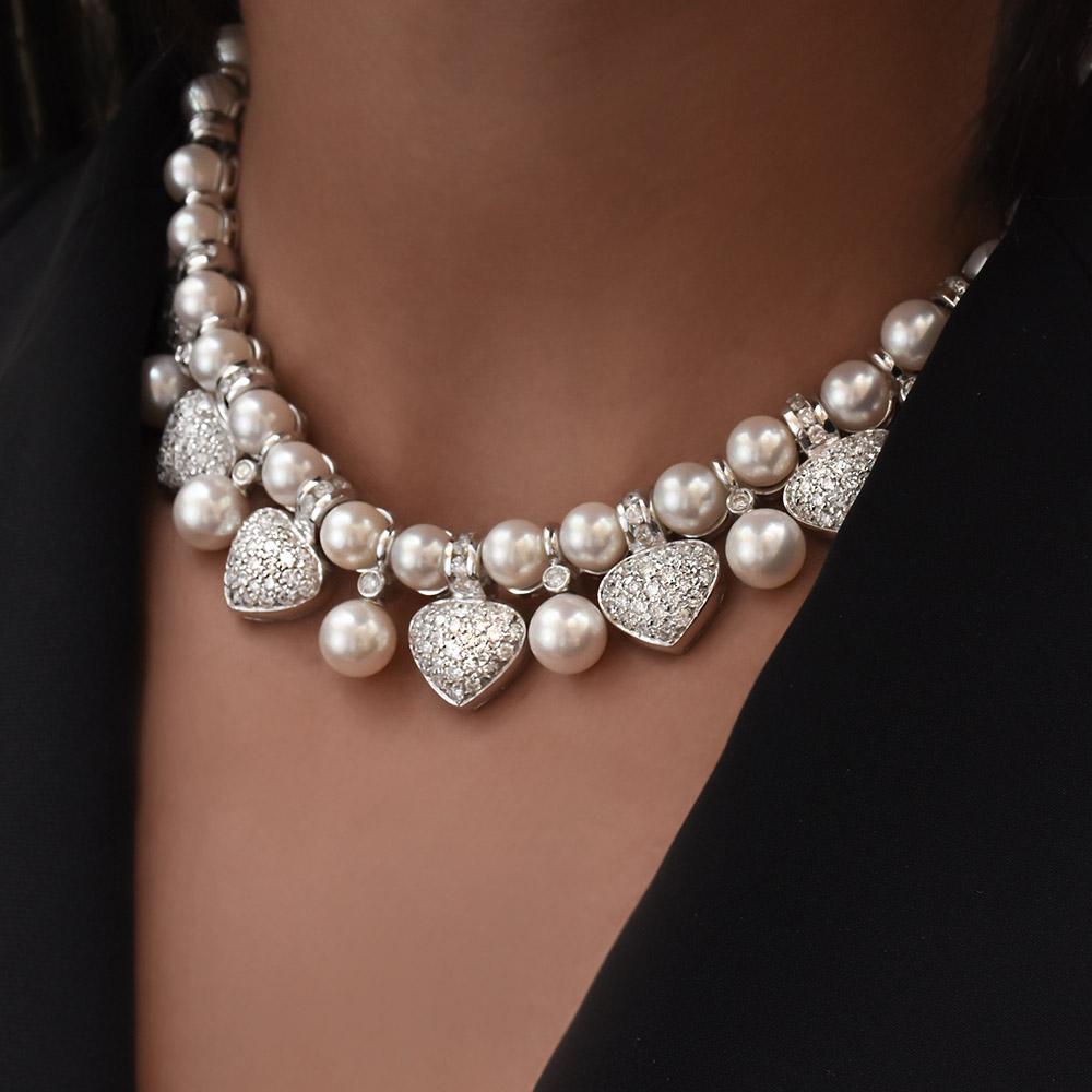 Feel like a princess in this beautiful 18 karat white gold, diamond and pearl necklace created by Tannler of Switzerland. The necklace features 9 diamond hearts bead set with round brilliant diamonds. The hearts are graduated from 14mm to 9mm. The