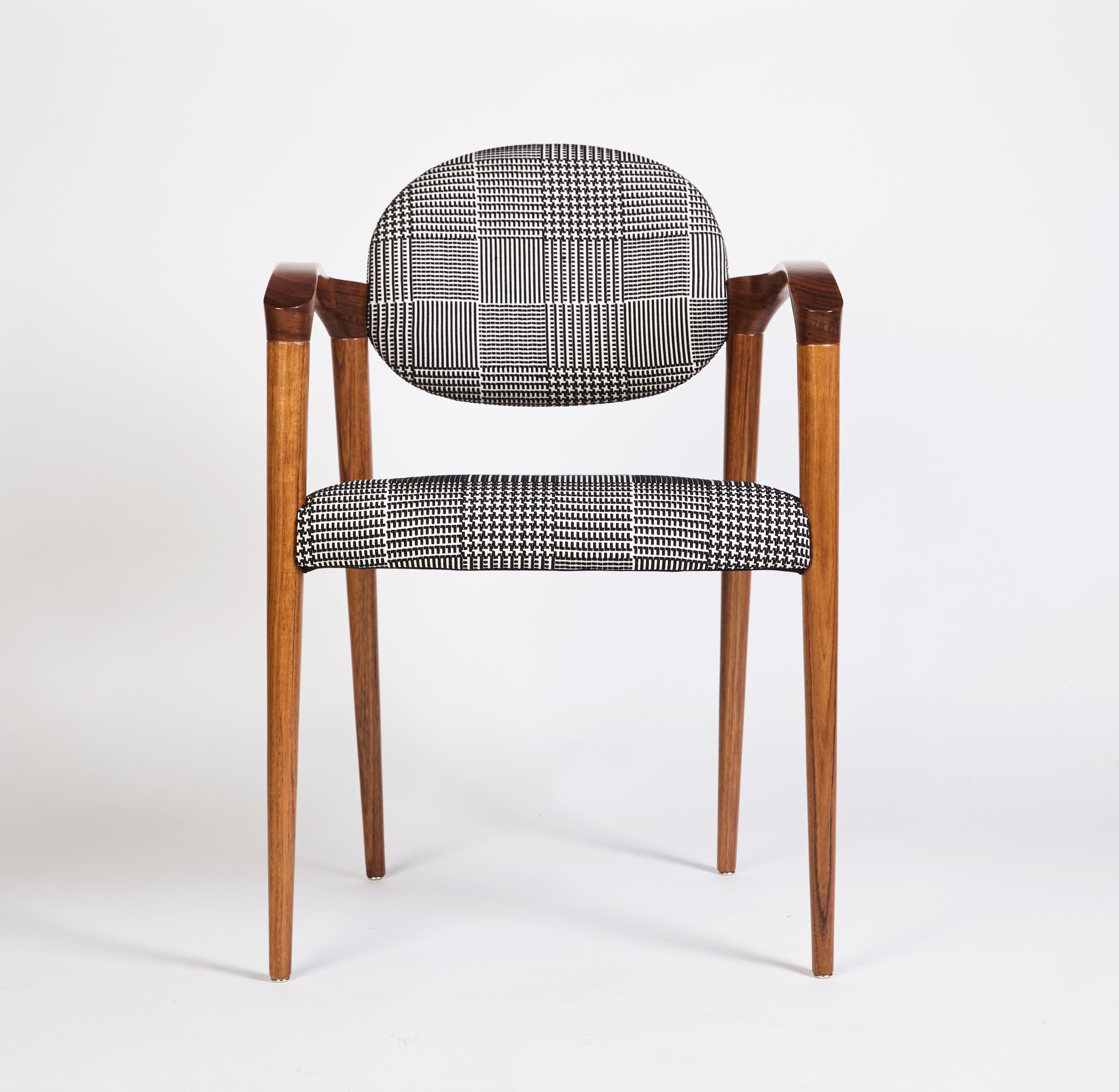 Tanoco Chair by DUISTT 
Dimensions: W 56 x D 58 x H 84 cm
Materials: Satin Mutenye Wood, Fabric SF.DE.21.001

Tanoco chair is inspired by the mid-century architecture and interior design, with its long arches creating simultaneously a sensation of