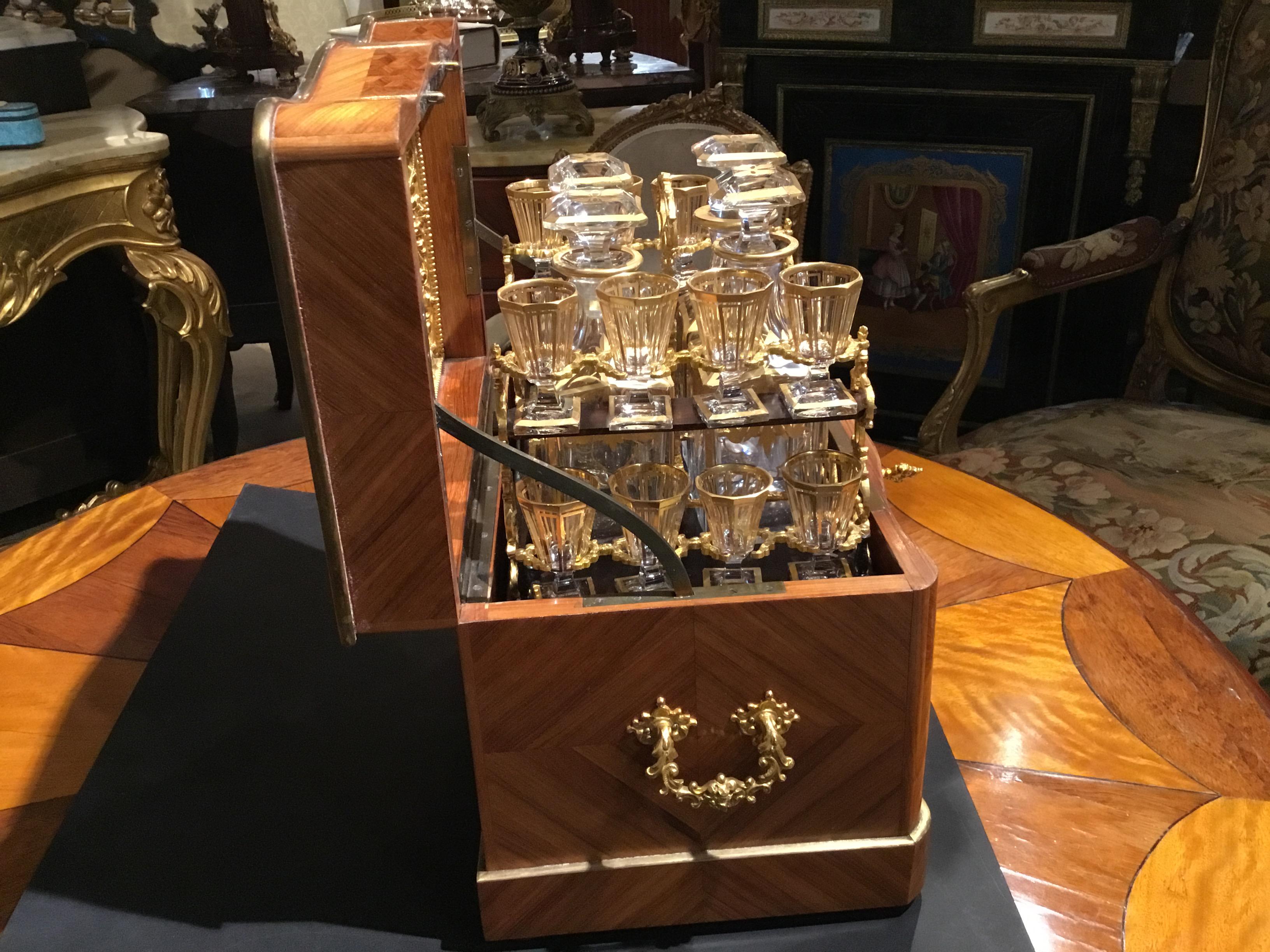 Exceptional set that has all the original glasses and carafes. The bottom of the
Glasses marked Baccarat. Marquetry comprised of rosewood, kingwood and
Tulipwood that is in beautiful condition. Bronze doré handles enhance the
Sides of this case