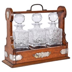Tantalus with Three Crystal Decanters in Oak Wood and Silver, England 19th Cent