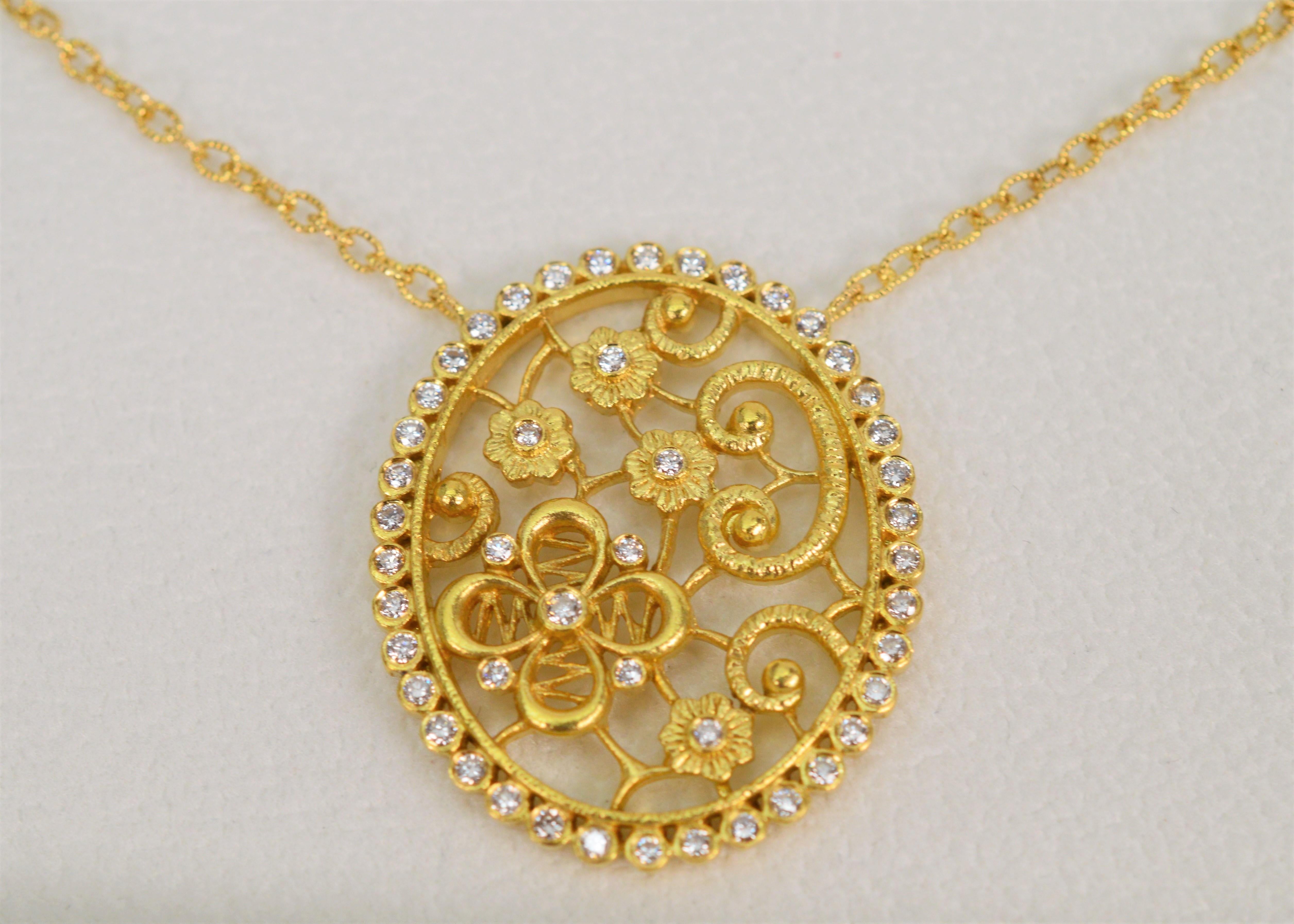 Stunning, by New York based designer Tanya Farah, this eighteen karat 18K yellow gold pendant necklace is a timeless work of art. Handcrafted, a flora inspired tapestry of golden buds on the vine featuring her four petal flower is accented and