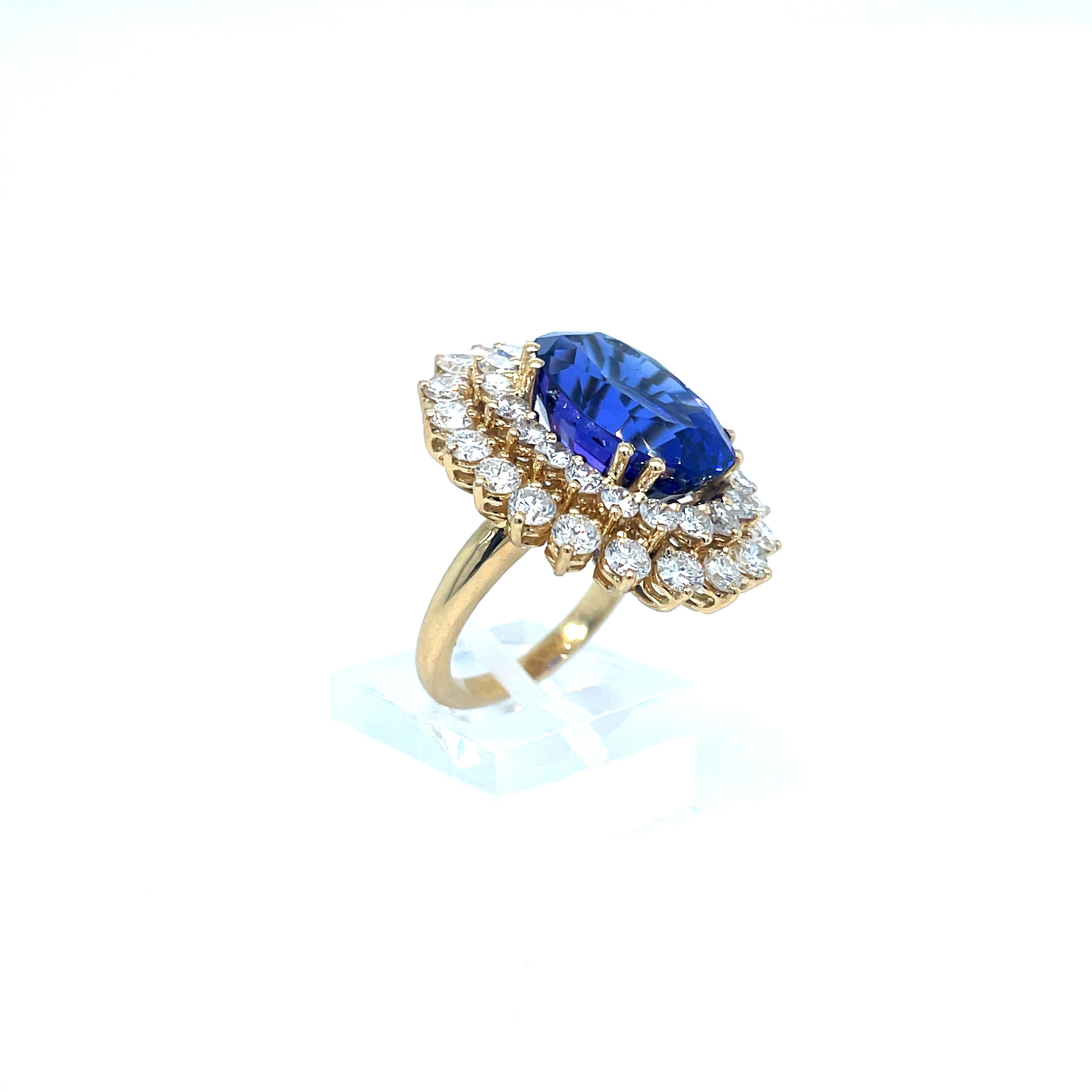 Tanzanite and Diamond Ring in 18K Yellow Gold. The ring features an 11ct oval tanzanite surrounded by a double halo of diamonds (4ctw). Finger size 6, can be sized.

Ring 1.125