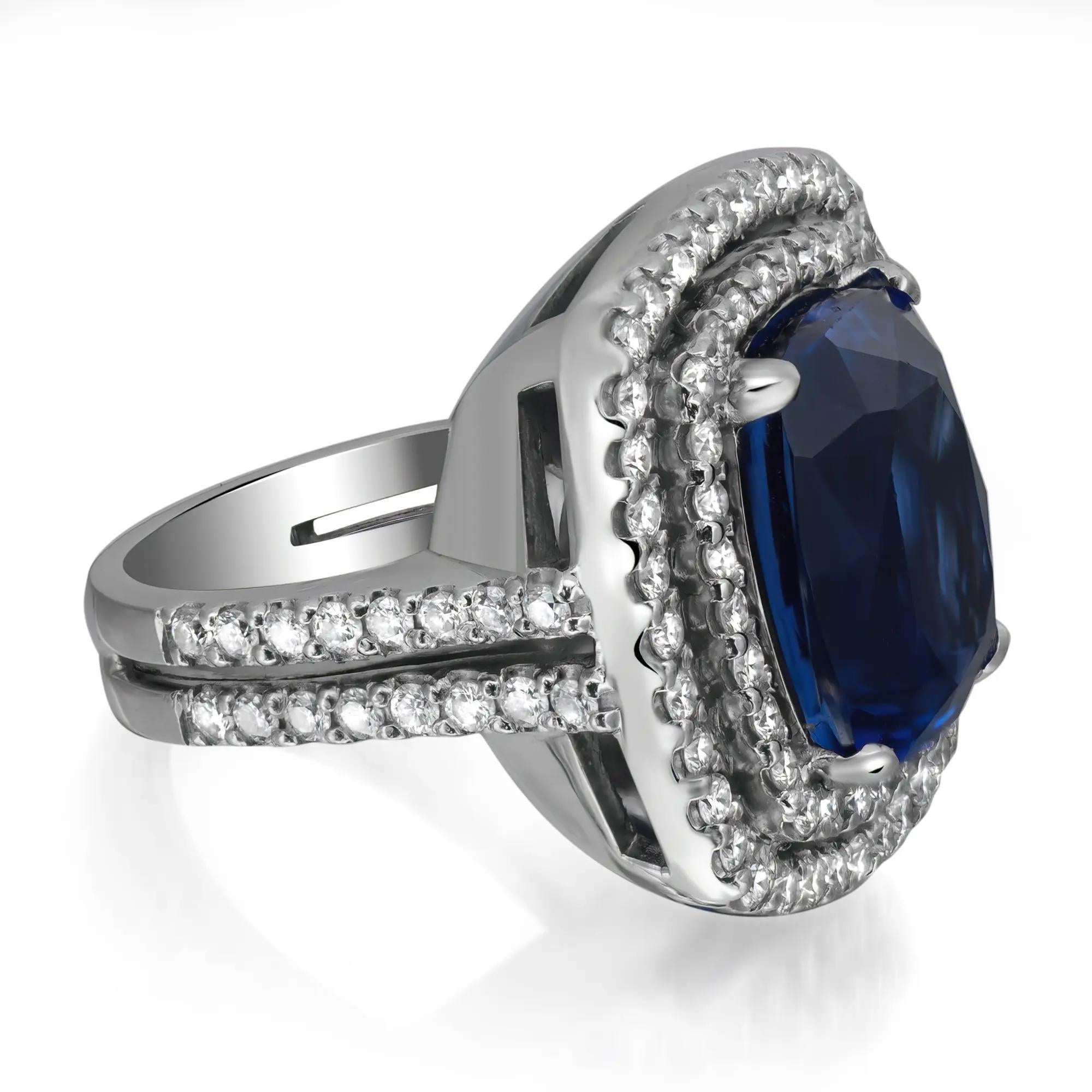 A large and luscious, vibrant ocean blue, Cushion mixed cut tanzanite weighing 17.03 carats glistens and glows from sizzling whimsical double halo composed of 1.74 carats of bright white and sparkling round brilliant cut diamonds with more diamonds