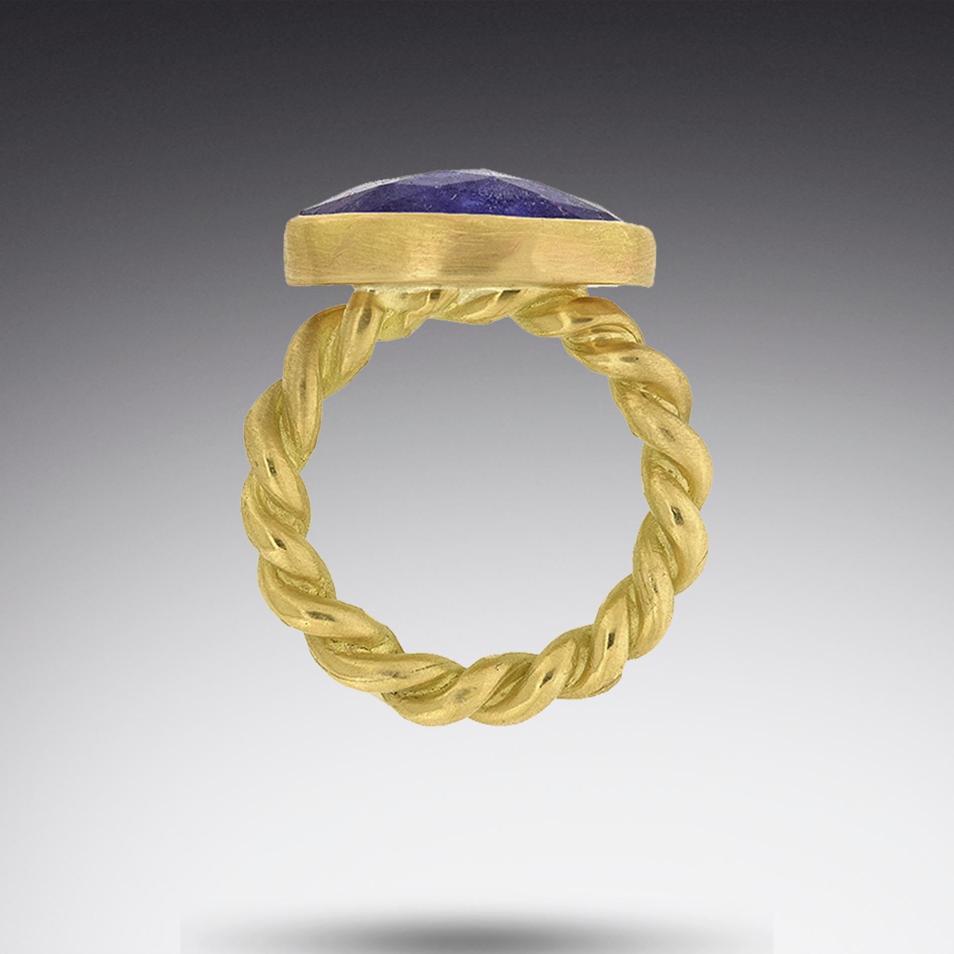 An 18K gold rope band supports this 12 carat Rose-cut Tanzanite.  A simple statement and one of a kind.  

Size 5-1/4