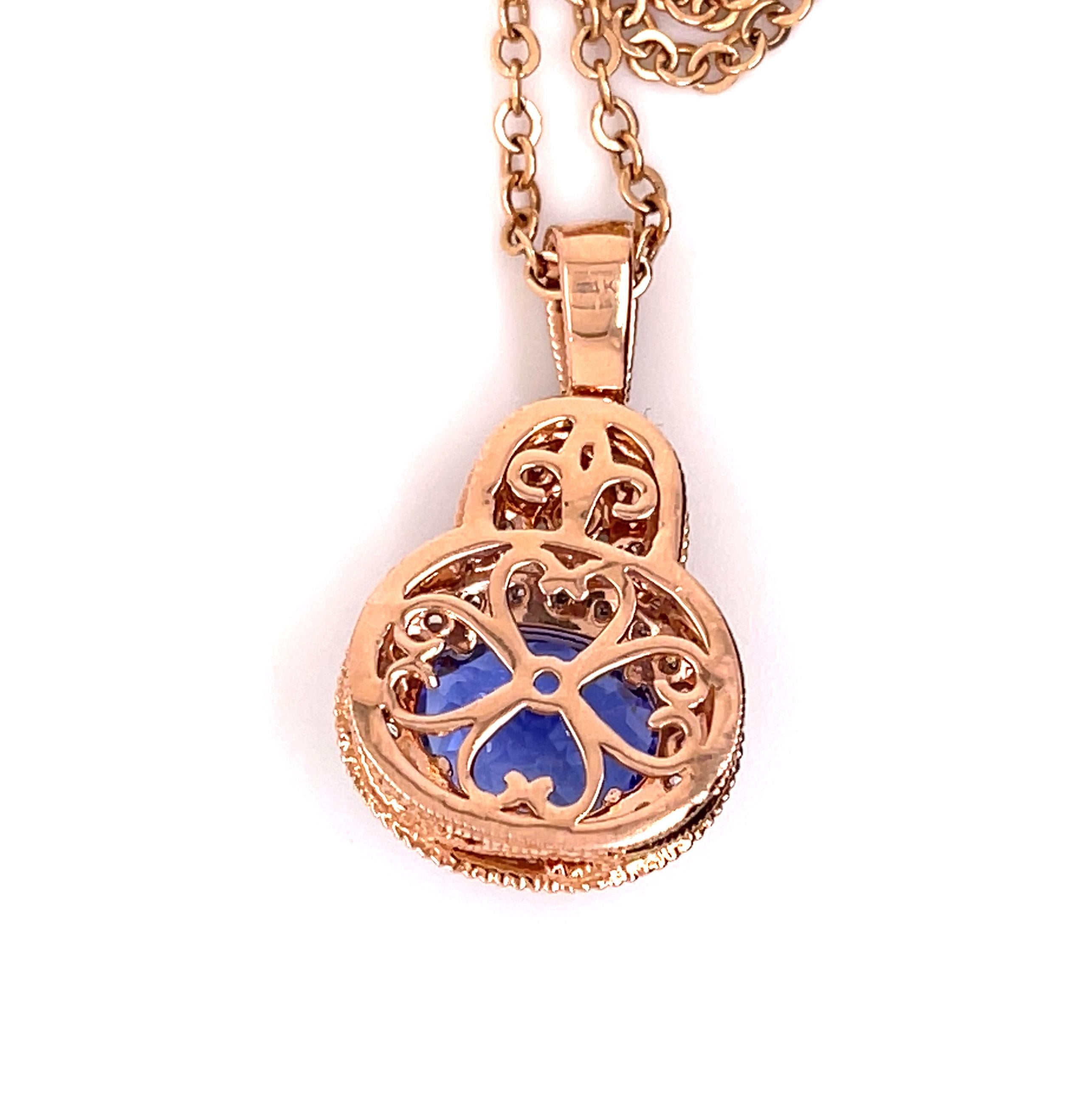 This nice violet-blue 3.74 carats Tanzanite is set in 14-karat rose-gold with a beautifully designed basket setting and four prongs. The Tanzanite is accented with 33 brilliant-cut round diamonds. The back of the pendant has a beautiful heart