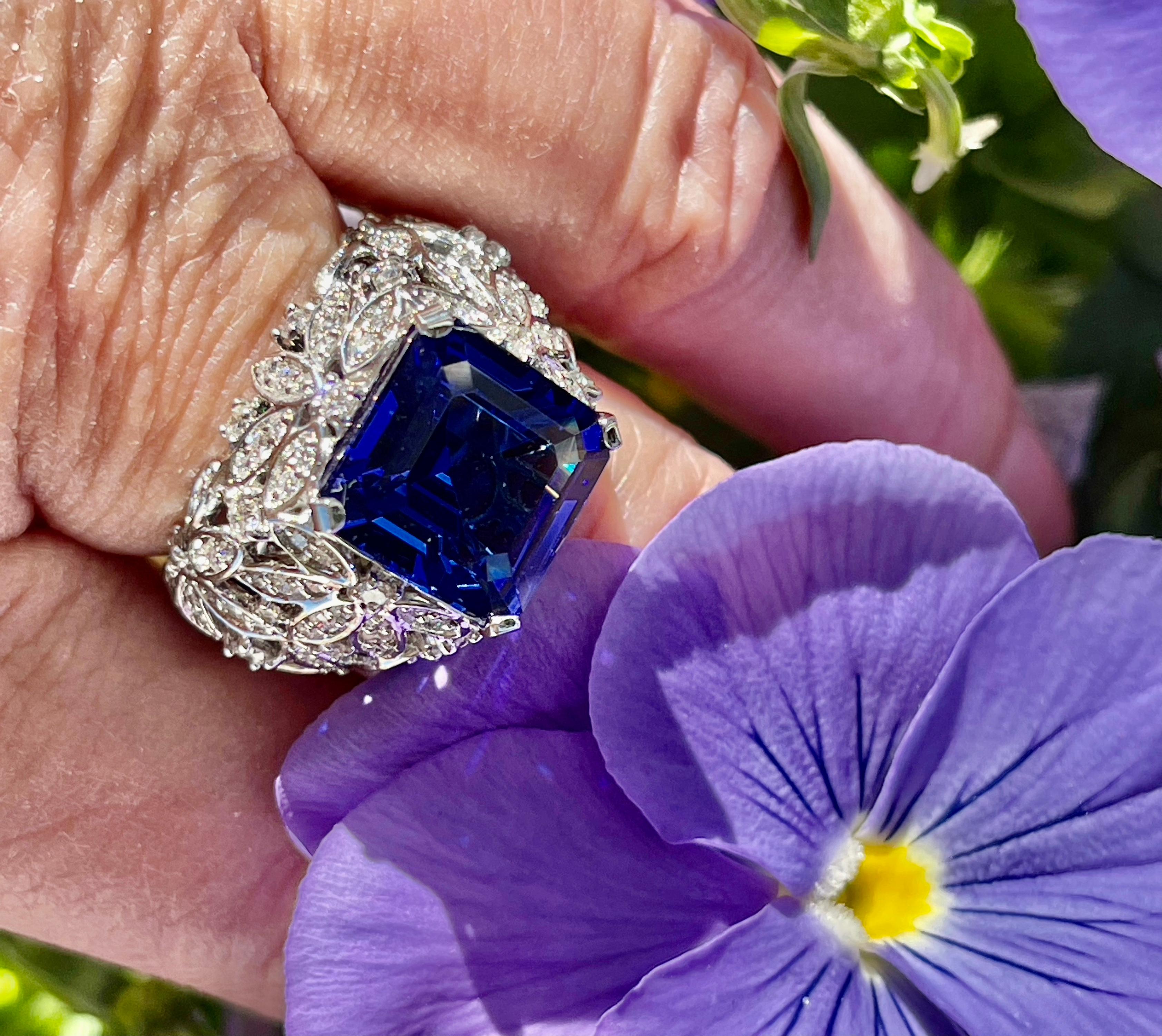 This exceptionally well cut and saturated violet-blue 7.0 carats Tanzanite is set in 18-karat white gold with a beautifully designed dome setting and four prongs. The Tanzanite is accented with 1.56 carats of brilliant-cut round diamonds in the