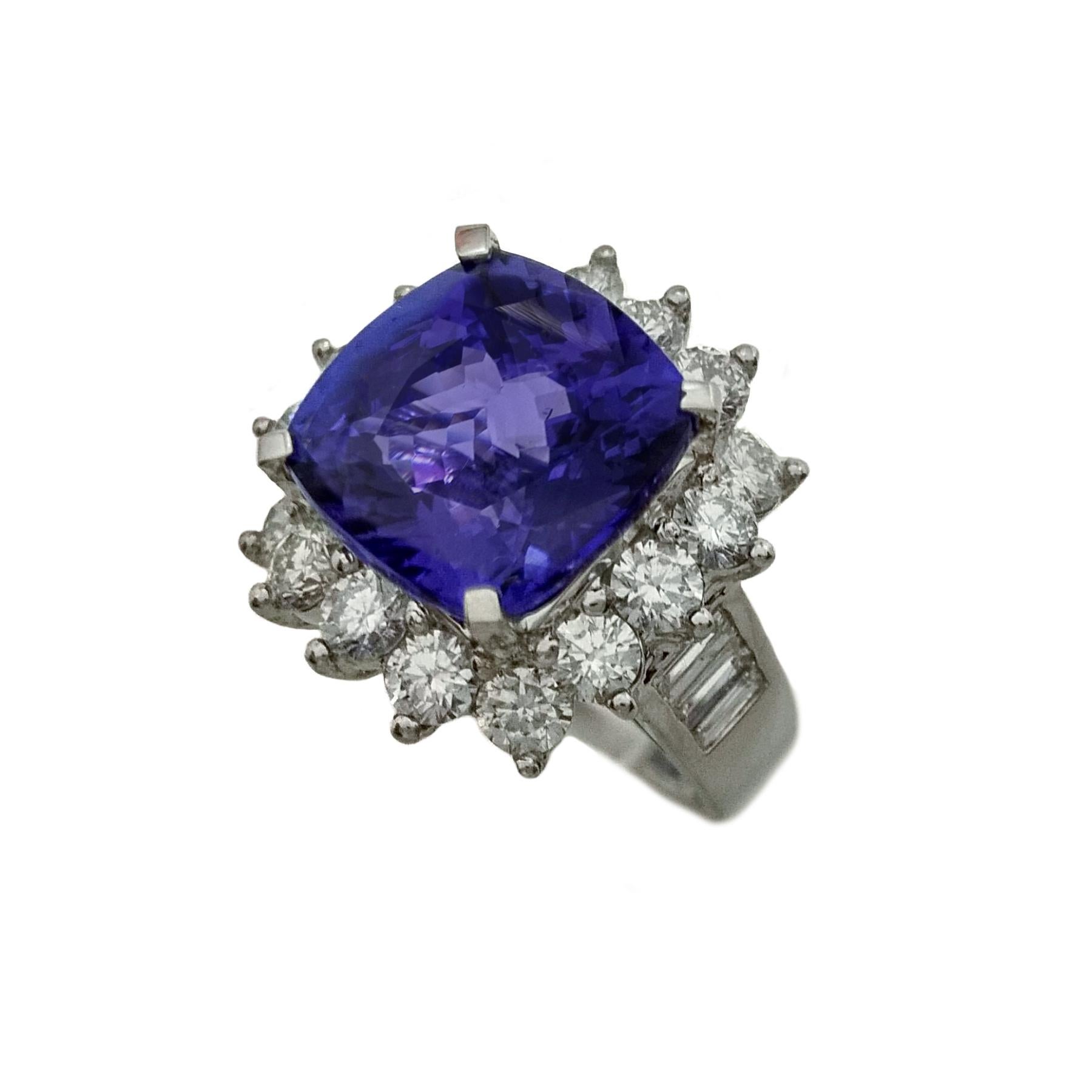 Glamorous cocktail tanzanite diamond ring. High luster, lively violet-purple, 8.31 carats cushion faceted tanzanite, set in high profile open basket with four prongs, accented with round brilliant diamond frame, and tapered diamonds on the shoulder.