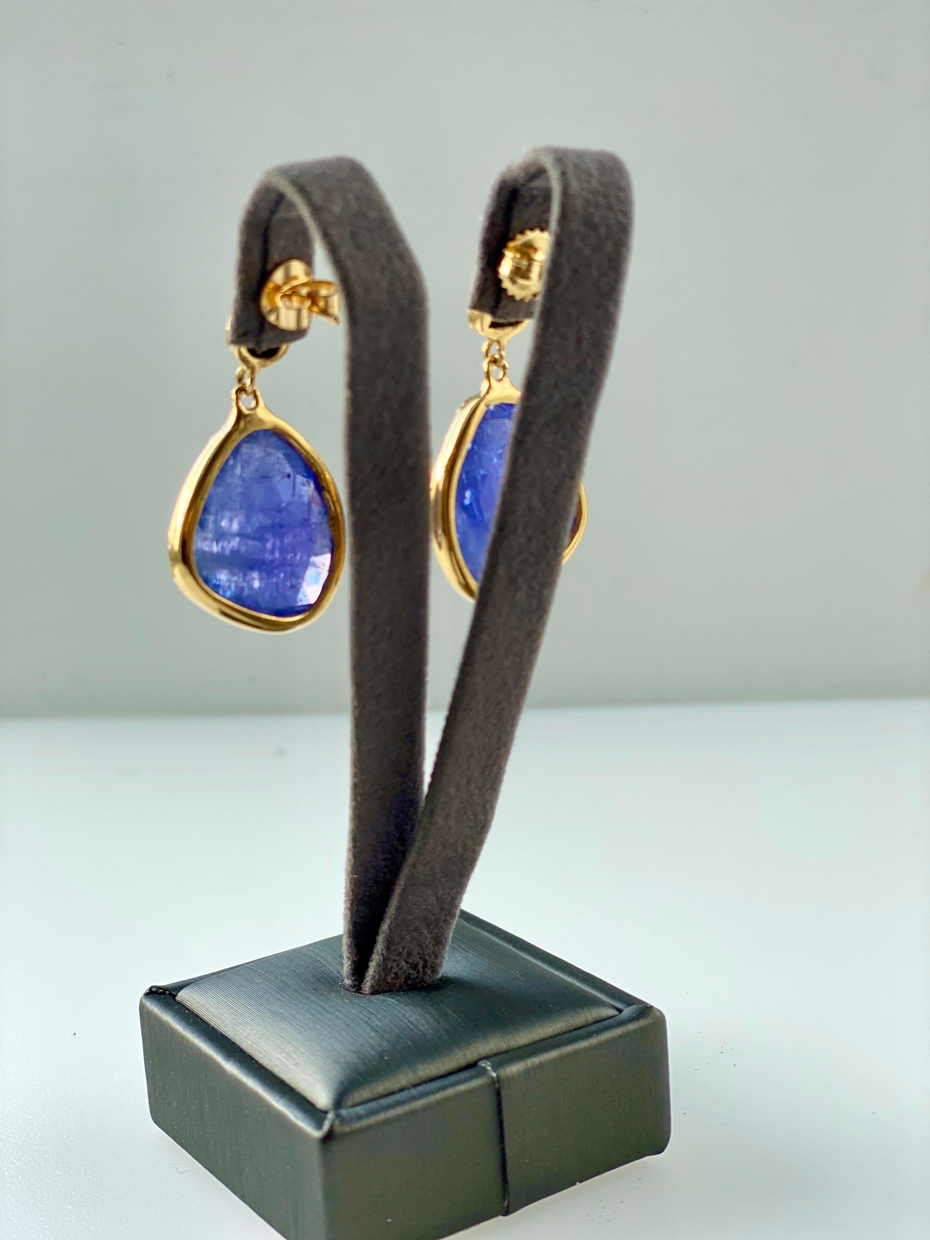 Delightful freeform pair of Tanzanite and Opal earrings set in 18K gold hand-hammered bezels.  One of a kind.