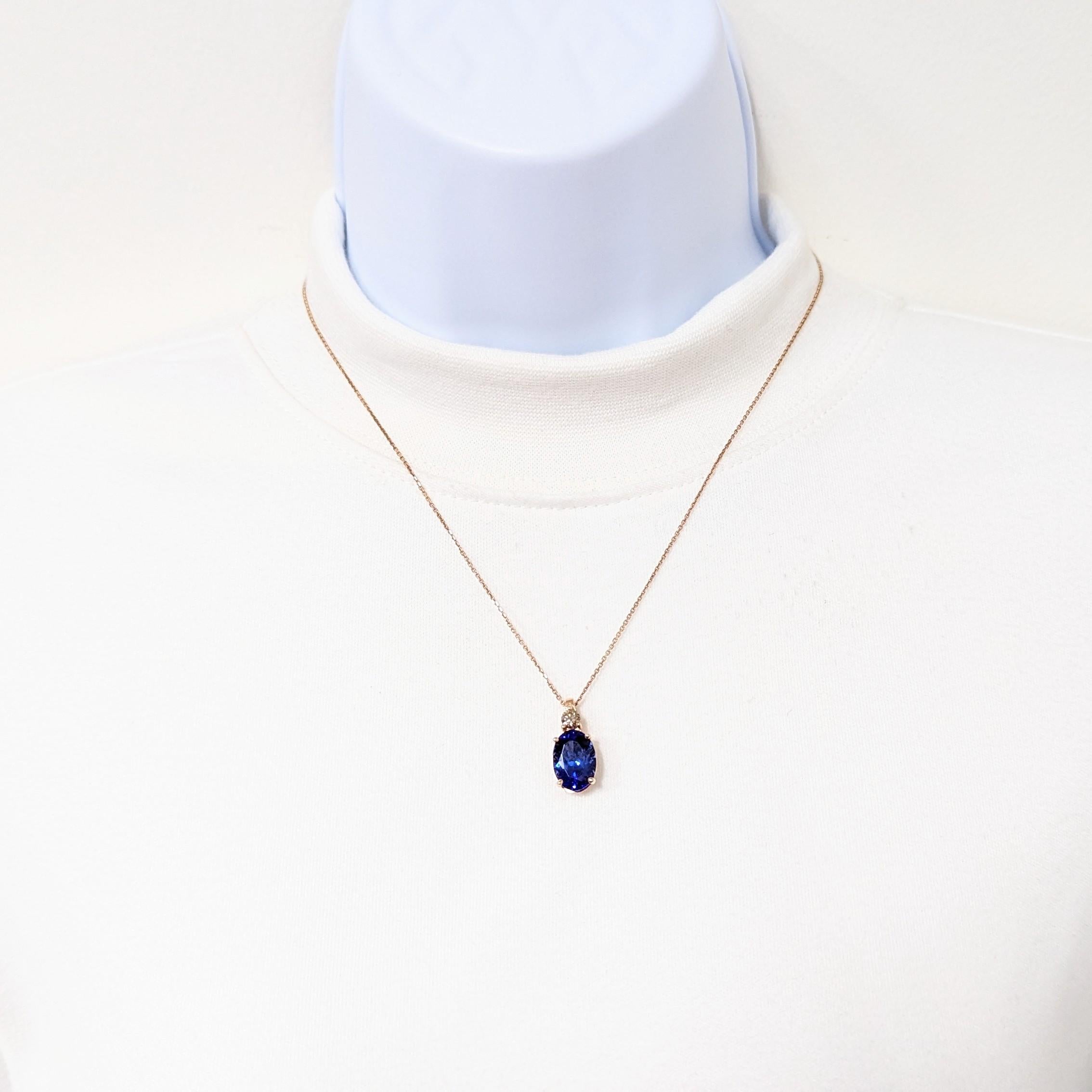 Beautiful 6.20 ct. tanzanite oval with 0.31 ct. champagne diamond rounds.  Handmade in 14k rose gold.  Length of chain is 18