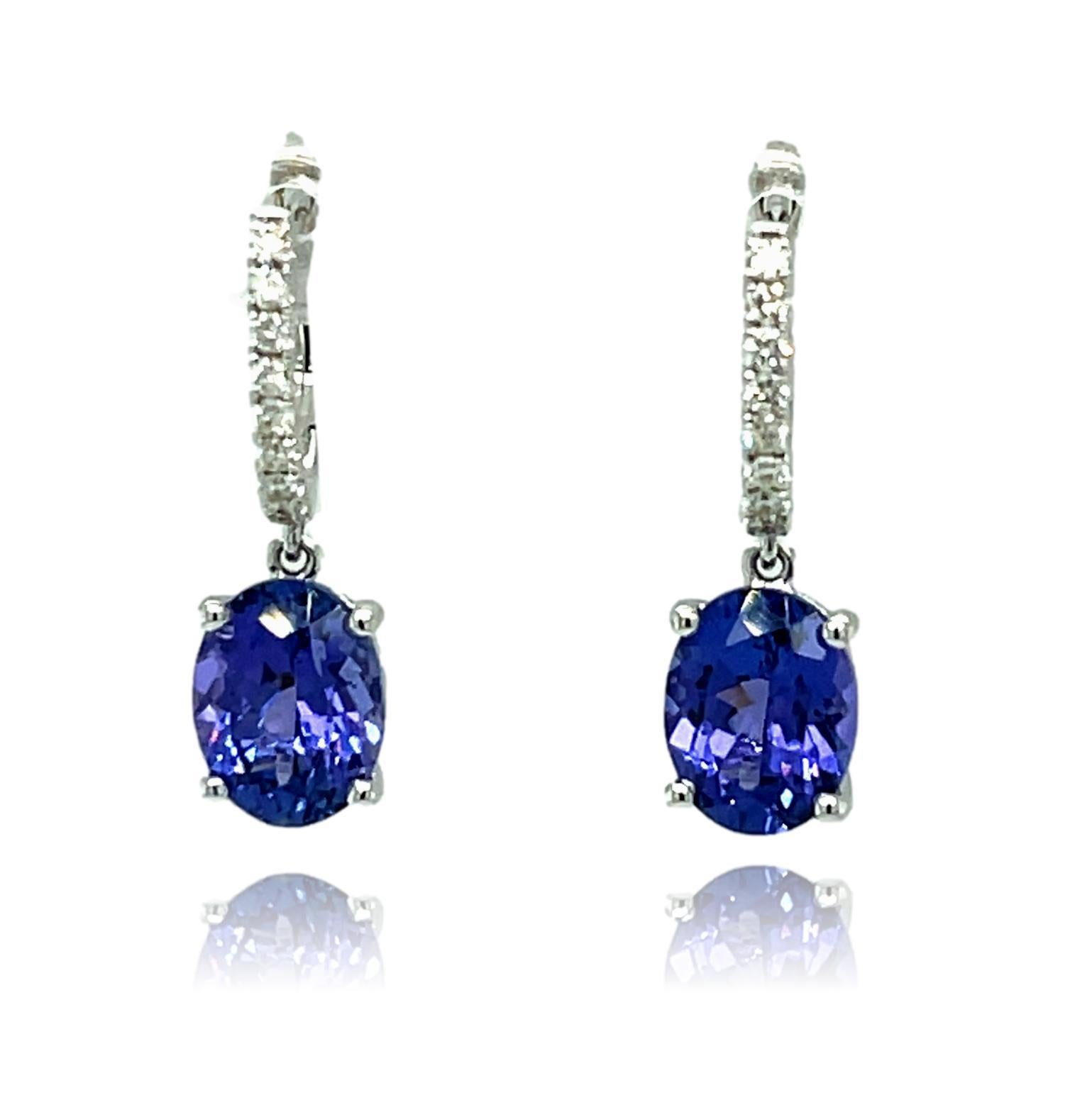 These stunning oval Tanzanite hoop earrings are beautiful for that special event. They have shimmering brilliant cut diamonds on the hoop for the perfect accent. There is a double push lock for extra security. These earrings have detailed tags