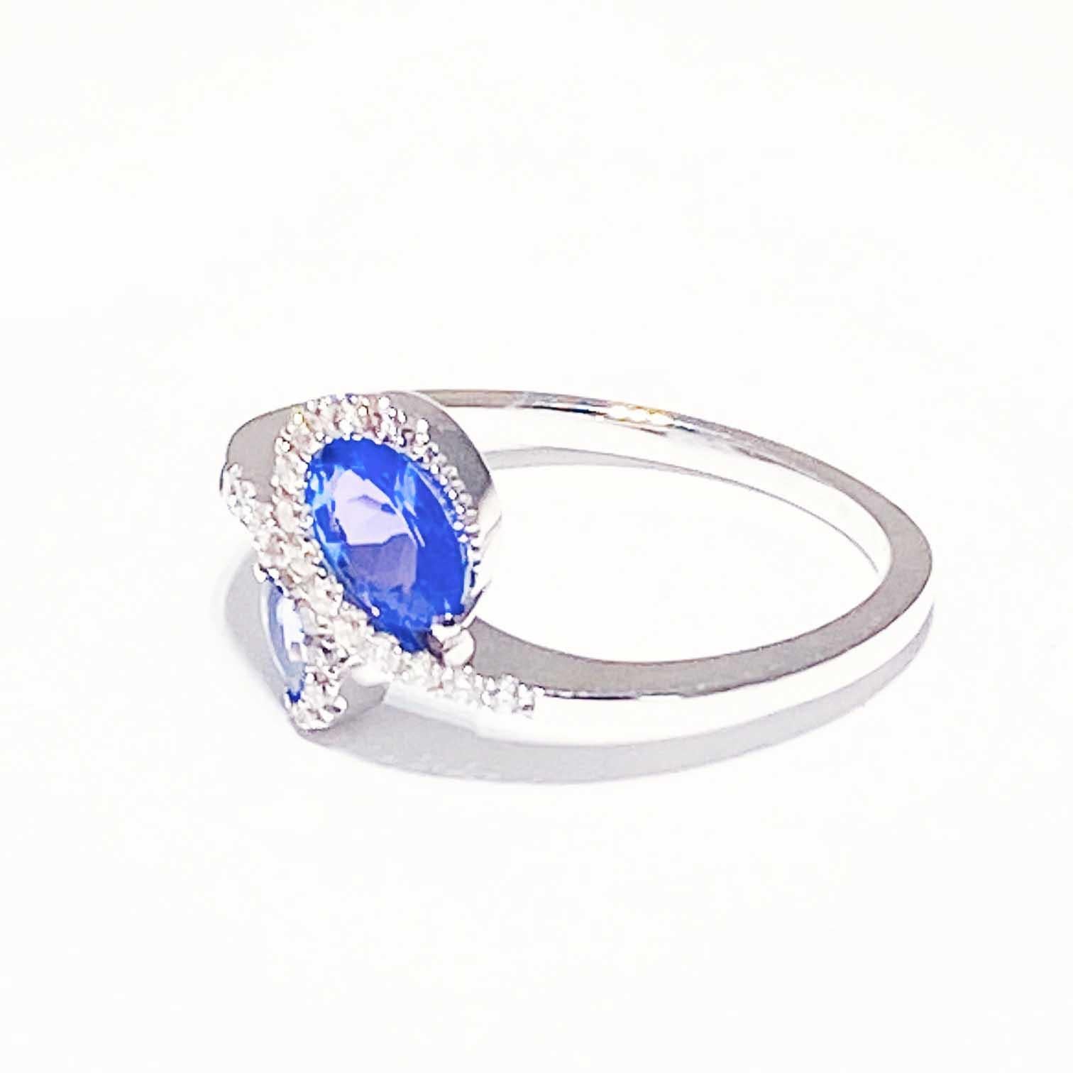Custom, Designer, Asymmetric design with genuine tanzanite and diamonds! The ring holds two gorgeous, genuine tanzanite gemstone that are framed by diamonds set in a bypass design. The ring setting is whimsical and stunning! This would make a great