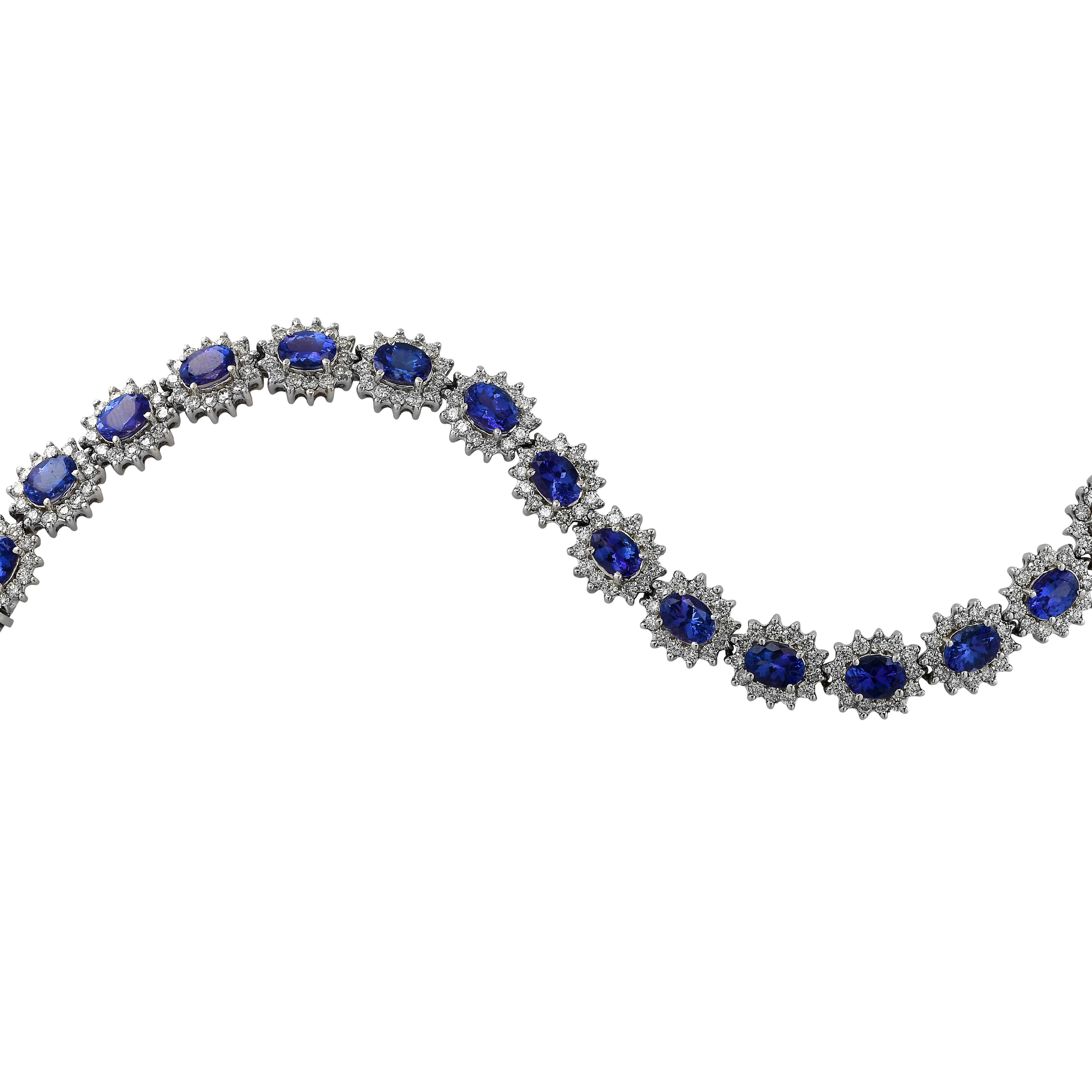 Stunning bracelet crafted in white gold, showcasing 16 oval cut tanzanites weighing approximately 16.70 carats total, and 196 round brilliant cut diamonds weighing approximately 6 carats total, H-I color VS-SI clarity. This regal bracelet measures