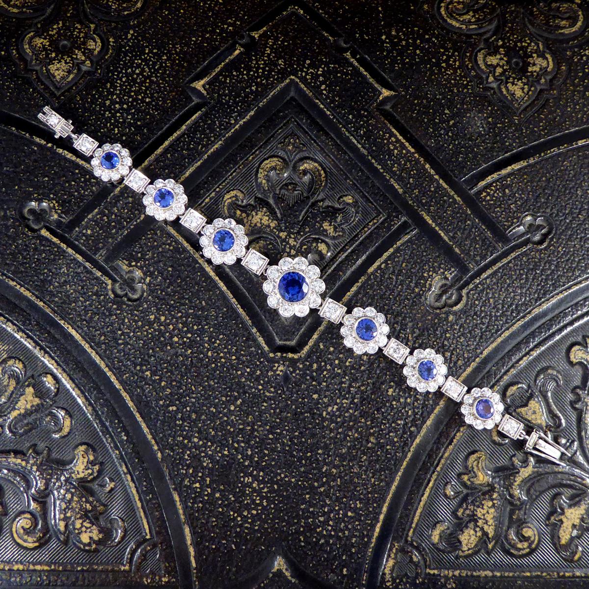 This absolutely stunning bracelet features 7 Tanzanite and Diamond clusters graduating in size with the largest in the centre. The clusters are interspaced by eight round brilliant cut Diamonds, grain set within a square shaped millegrain border