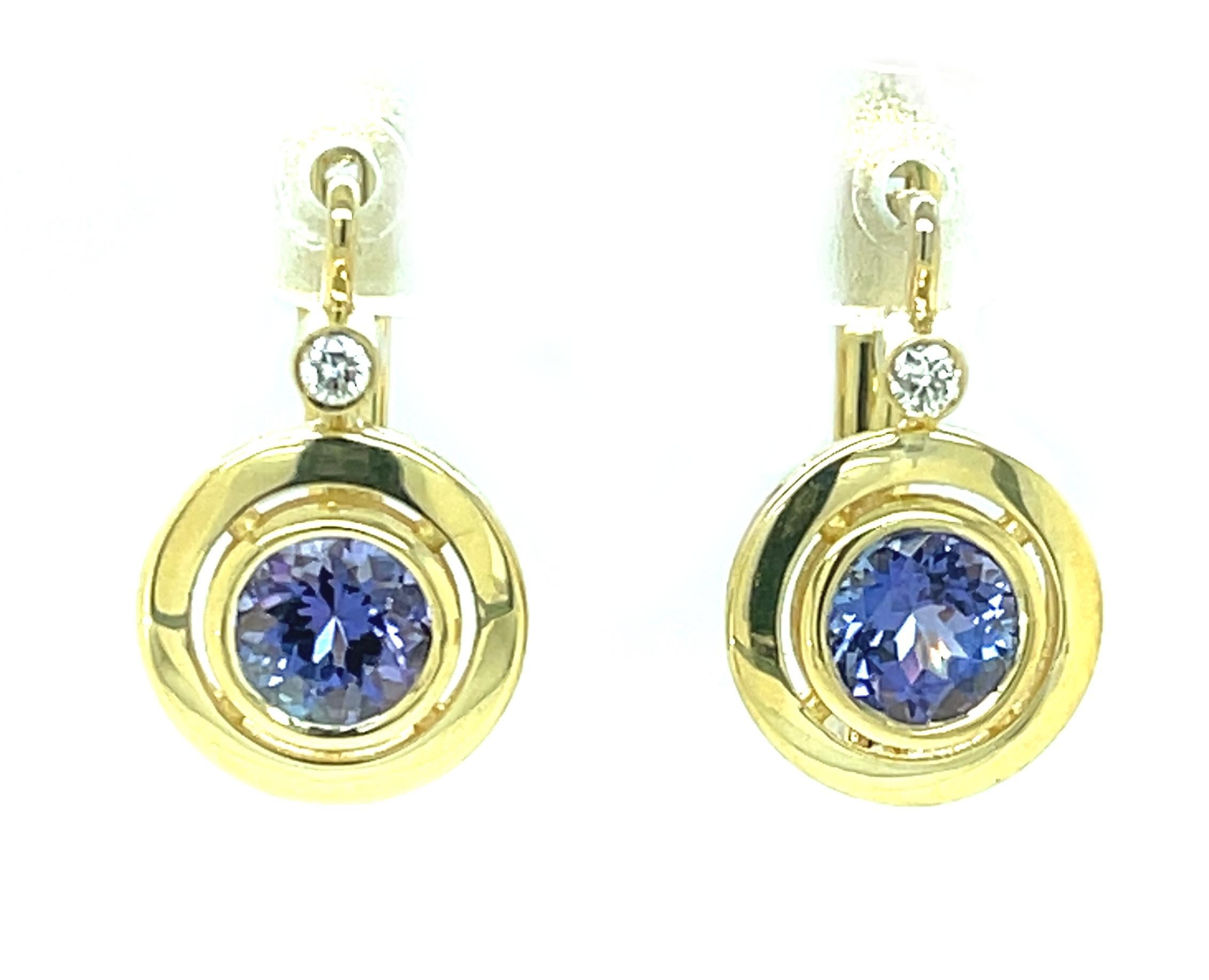 These tanzanite and diamond drop earrings will add a pop of color and elegance to any look! The gorgeous blue-violet tanzanites are the color of African violets in bloom, set in rich 18k yellow gold and topped with round brilliant white diamonds for