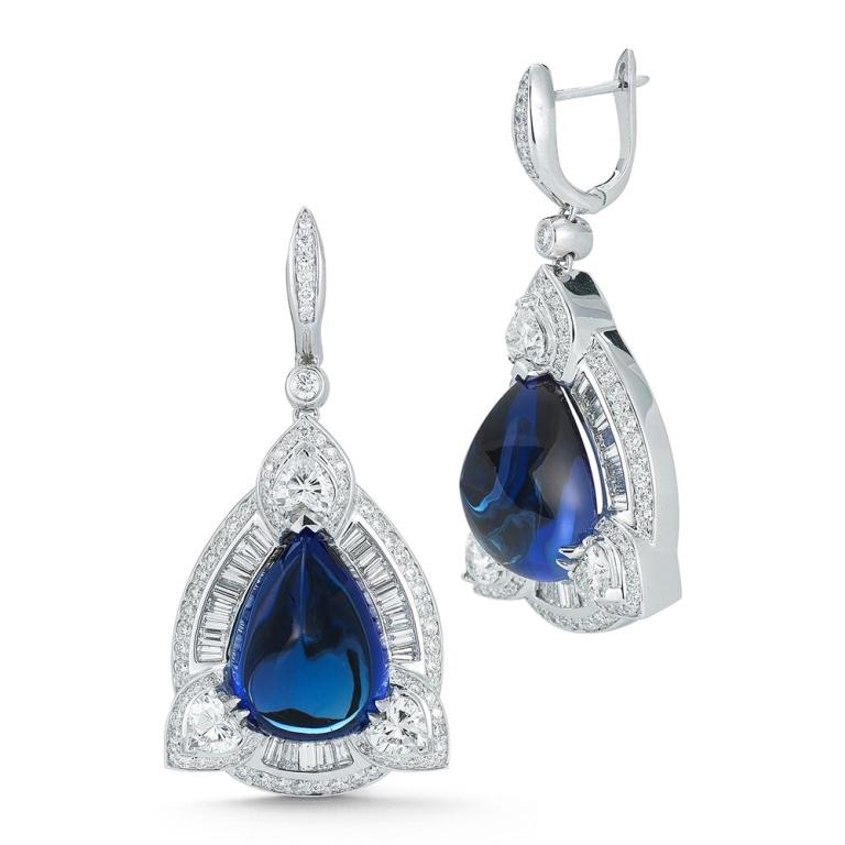 TANZANITE AND DIAMOND EARRING Mesmerizing Tanzanite cabochons glimmer within these diamond earrings. Item: # 01698 Metal: 18k W Lab: C.dunaigre Color Weight: 33.54 ct. Diamond Weight: 4.67 ct.
