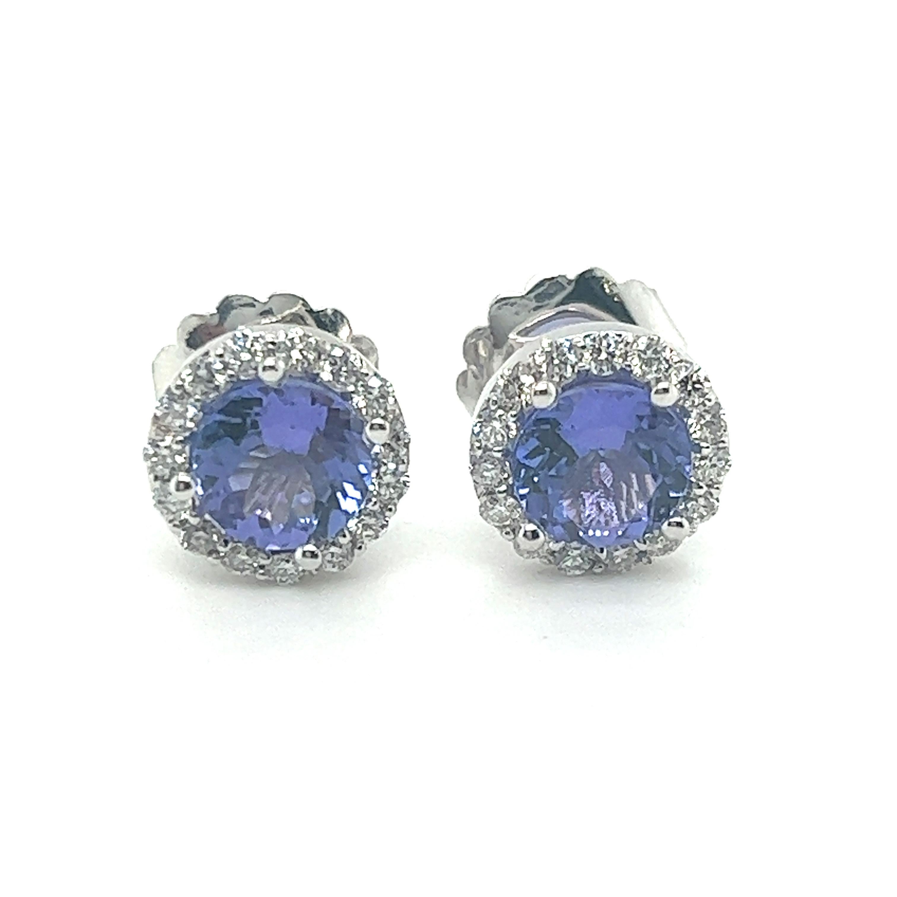 14k white gold Tanzanite Earrings
2.64 carats of Earth Mined Tanzanite 
Center Tanzanite stone is 7mm
.60 carats top quality Earth Mined Diamonds
Entire earring is 10.4mm in Diameter 
Handcrafted in the USA in Miami, FL 

Elegant Tanzanite Earrings,