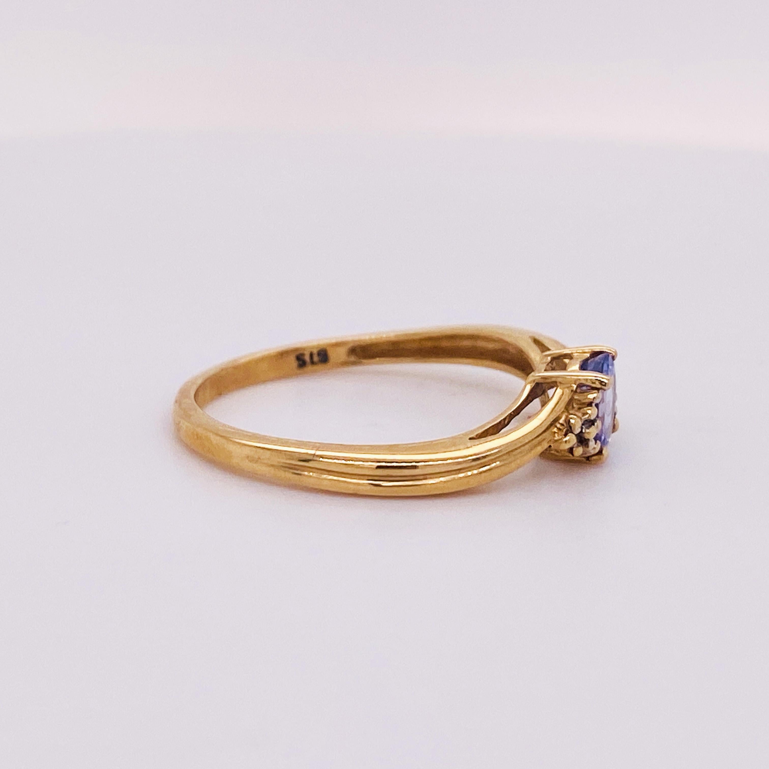 Like a bachelor button flower you can wear any time, this beautiful tanzanite floral ring has a graceful curve to the band and small gold pips around the tanzanite to give a feel that sweeps you away to a meadow any time you look at it. Sitting