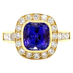 Anillo cóctel halo tanzanita y diamante oro amarillo 18k