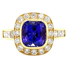 Tanzanite and diamond halo cocktail ring 18k yellow gold