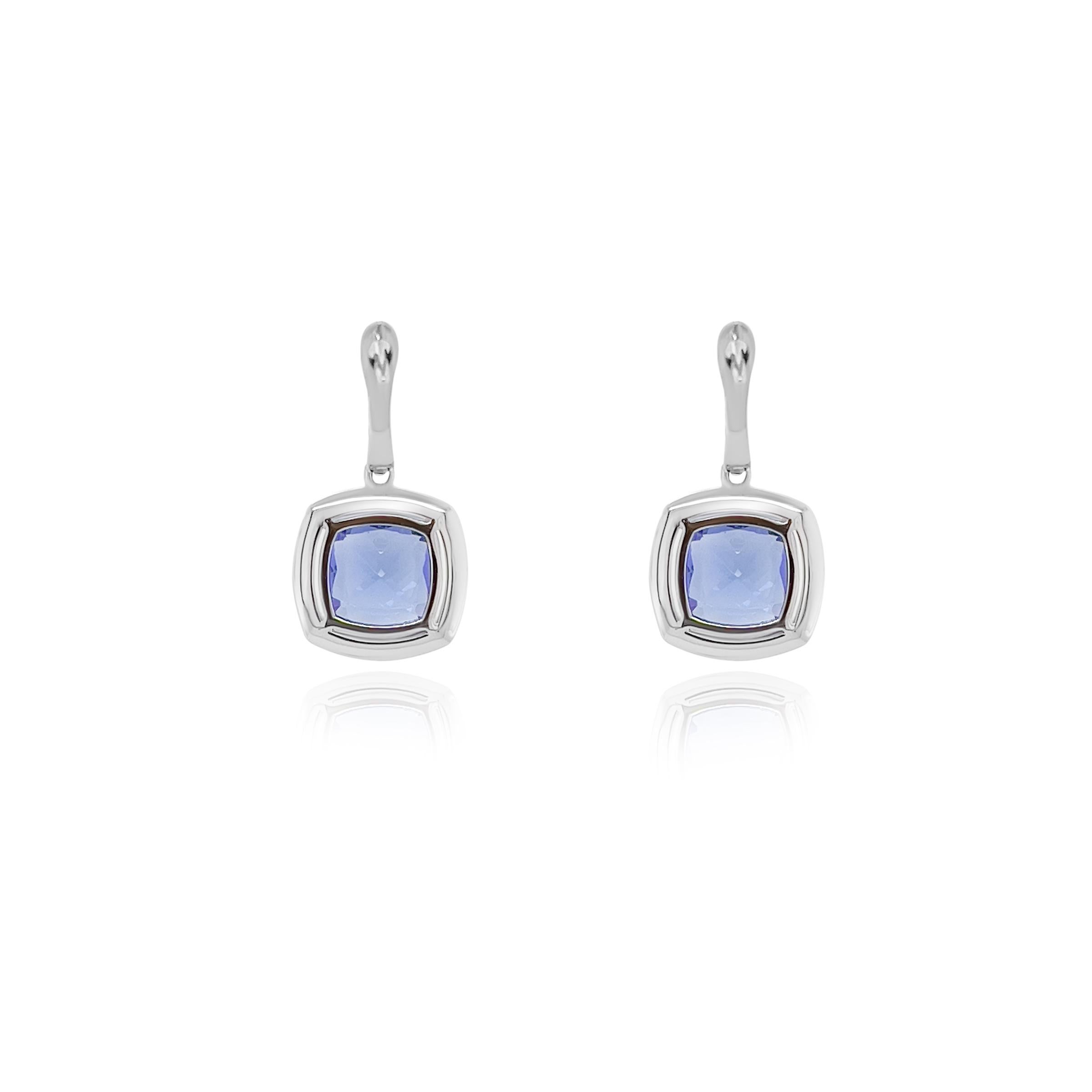 An exquisite pair of tanzanite and diamond earrings, the epitome of luxury and elegance. These stunning earrings feature clean and sparkling cushion cut tanzanite weighing a total of 4.180 carats. 

The vibrant tanzanites are magnificently