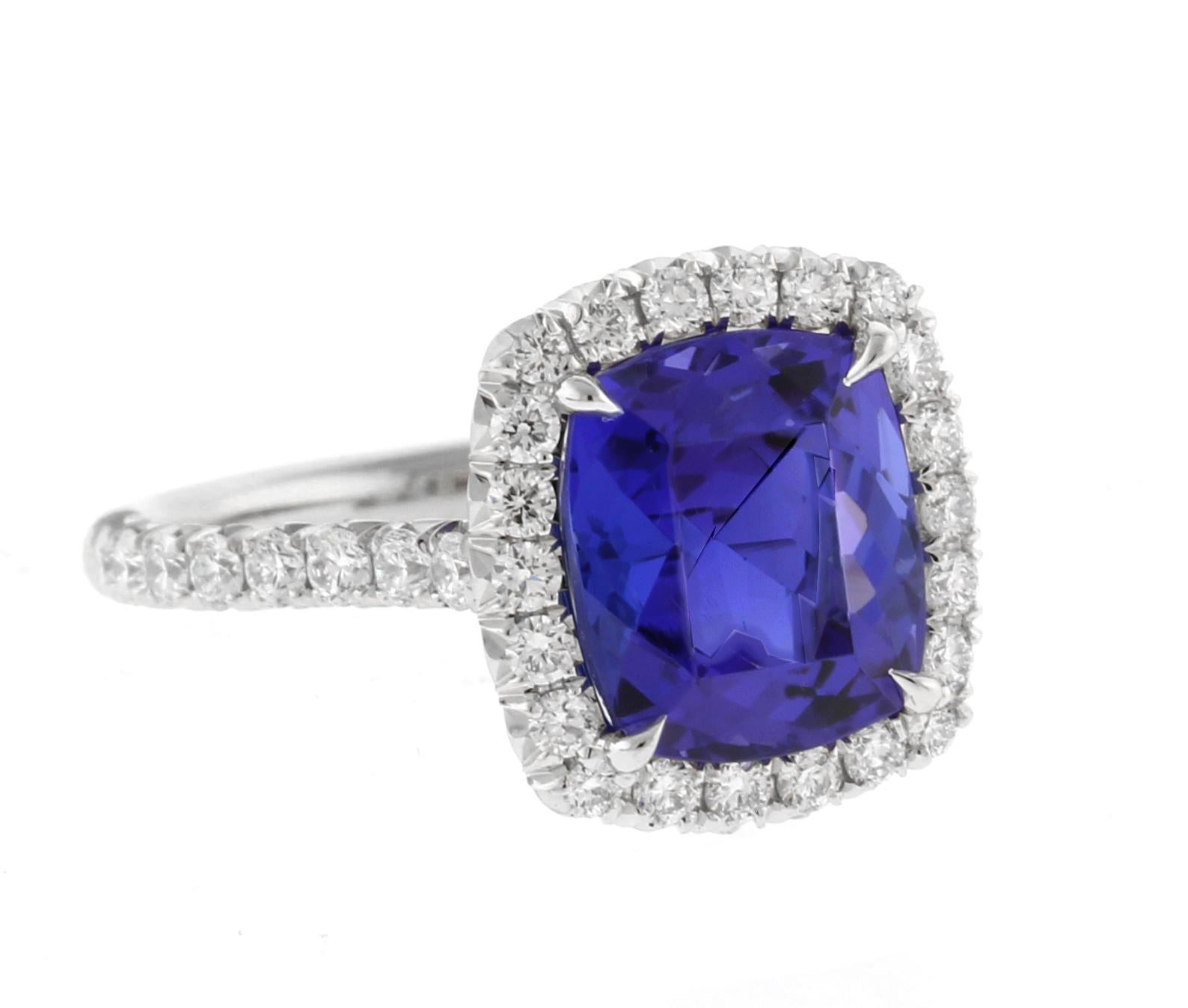 Experience the allure of this platinum tanzanite and diamond ring, featuring a breathtaking 3.47ct cushion-cut tanzanite. The platinum craponia style setting is adorned with 38 round diamonds totaling 0.66cts, creating a dazzling display of light