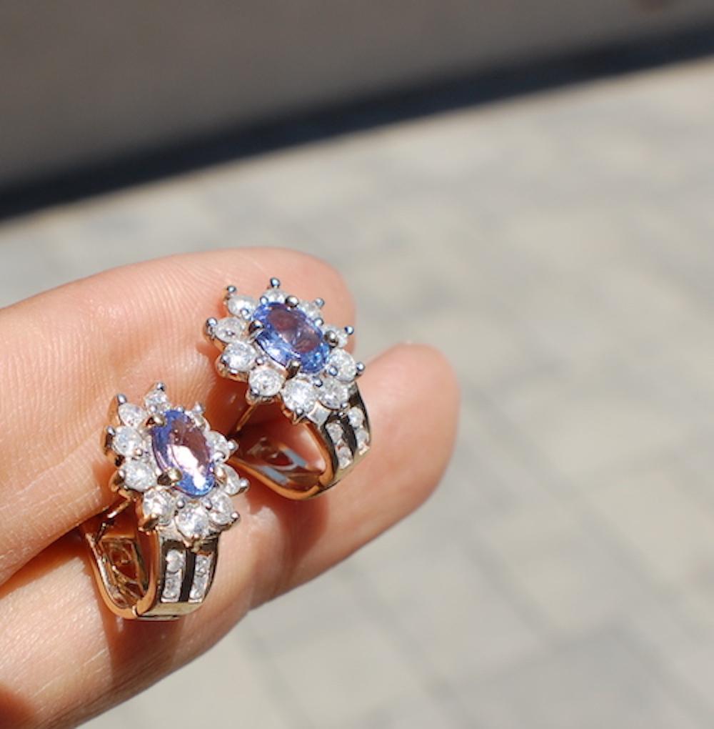 Tanzanite-Diamond, Huggy Earrings with vibrant blue color have a total weight of 2.15 carats and are set in 14 karat yellow gold.

The diamonds surrounding the center stone are (20) round diamonds measuring 2.50 mm with a total weight of 1