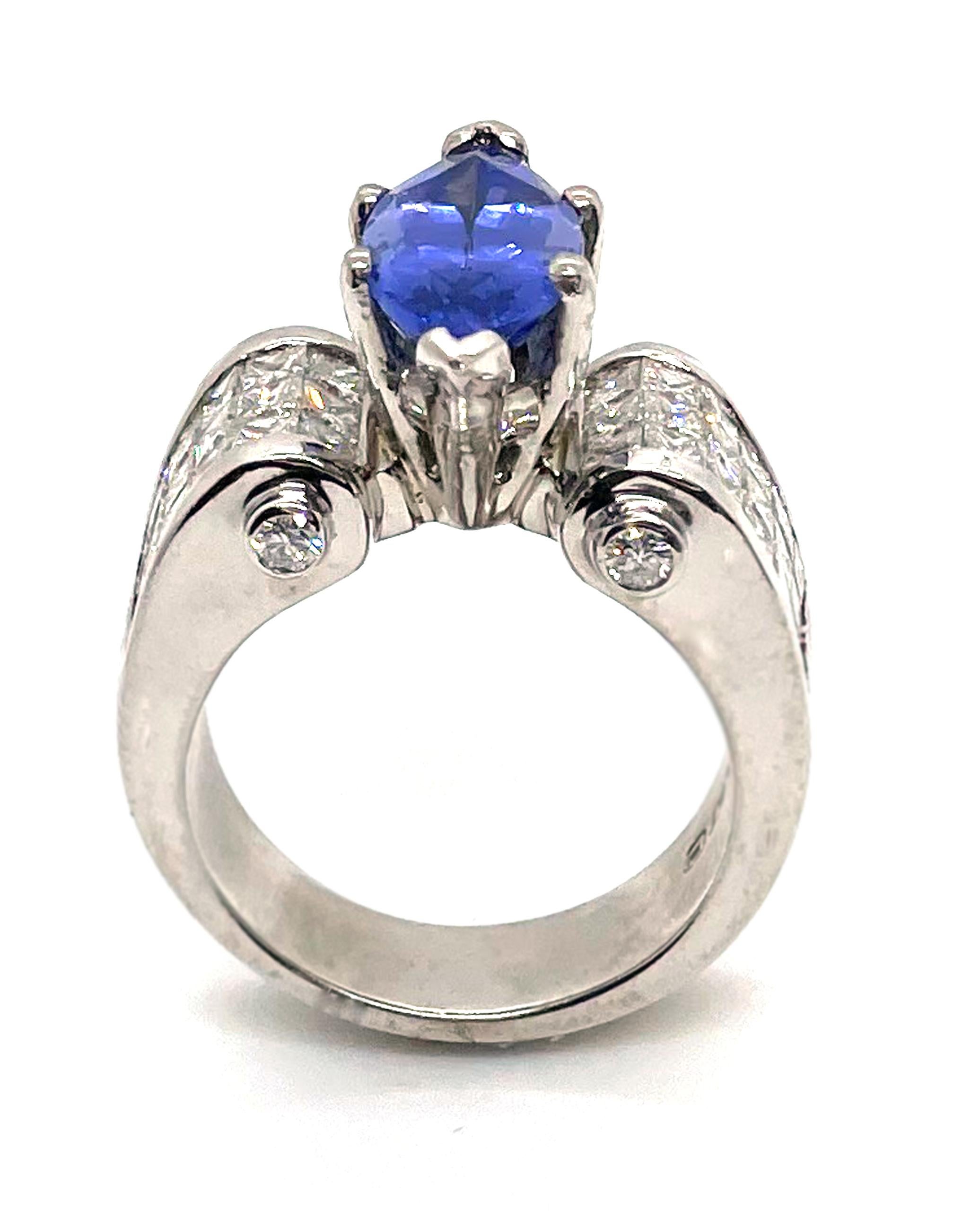 Platinum ring with 36 invisibly set princess-cut diamonds and 4 round brilliant-cut diamonds totaling 2.42 carats (G color, VVS clarity). One center marquise shape tanzanite totaling 3.02 carats.

* Circa 1990
* Finger size 6.75