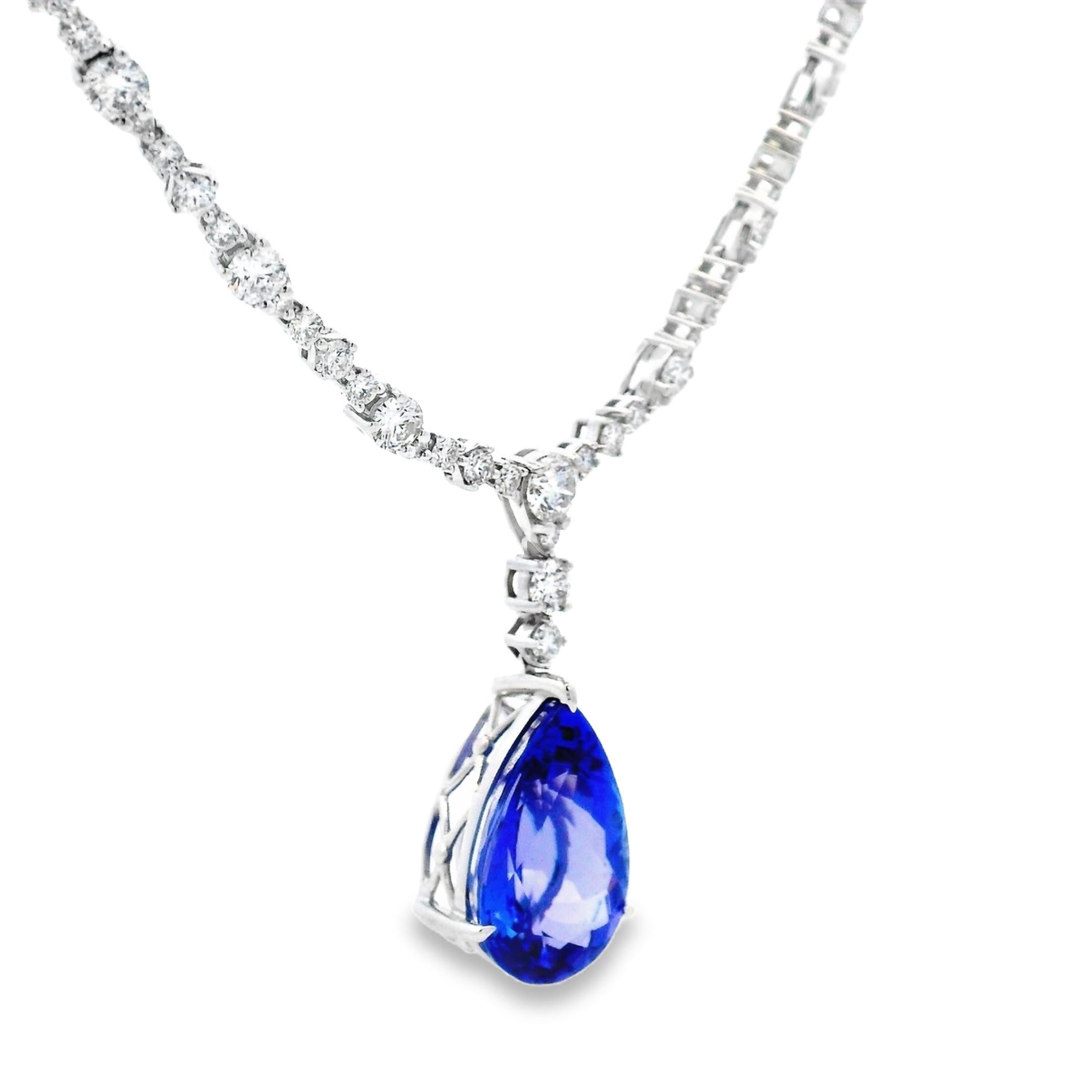 This 17-inch diamond and tanzanite necklace centers on a vivid 8.24-carat pear-shaped tanzanite, measuring 16.5mm x 11mm, set in a sculpted white gold basket. The pendant is suspended from a fully articulated collar set with 184 round brilliant