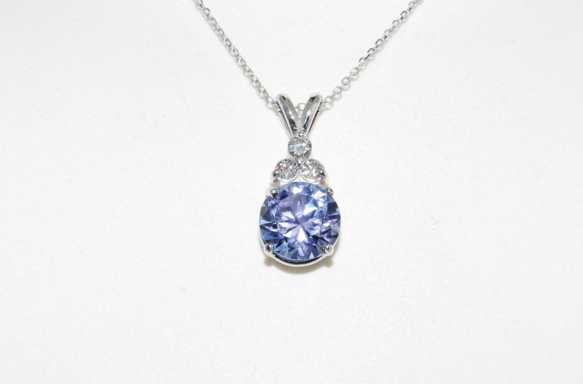 2.75 carat Tanzanite that was cut by AGTA award winning gem cutter Larry Woods. It is a light purple that some people just love. A brilliant stone accented by 3 small (0.3 carats each) diamonds. 