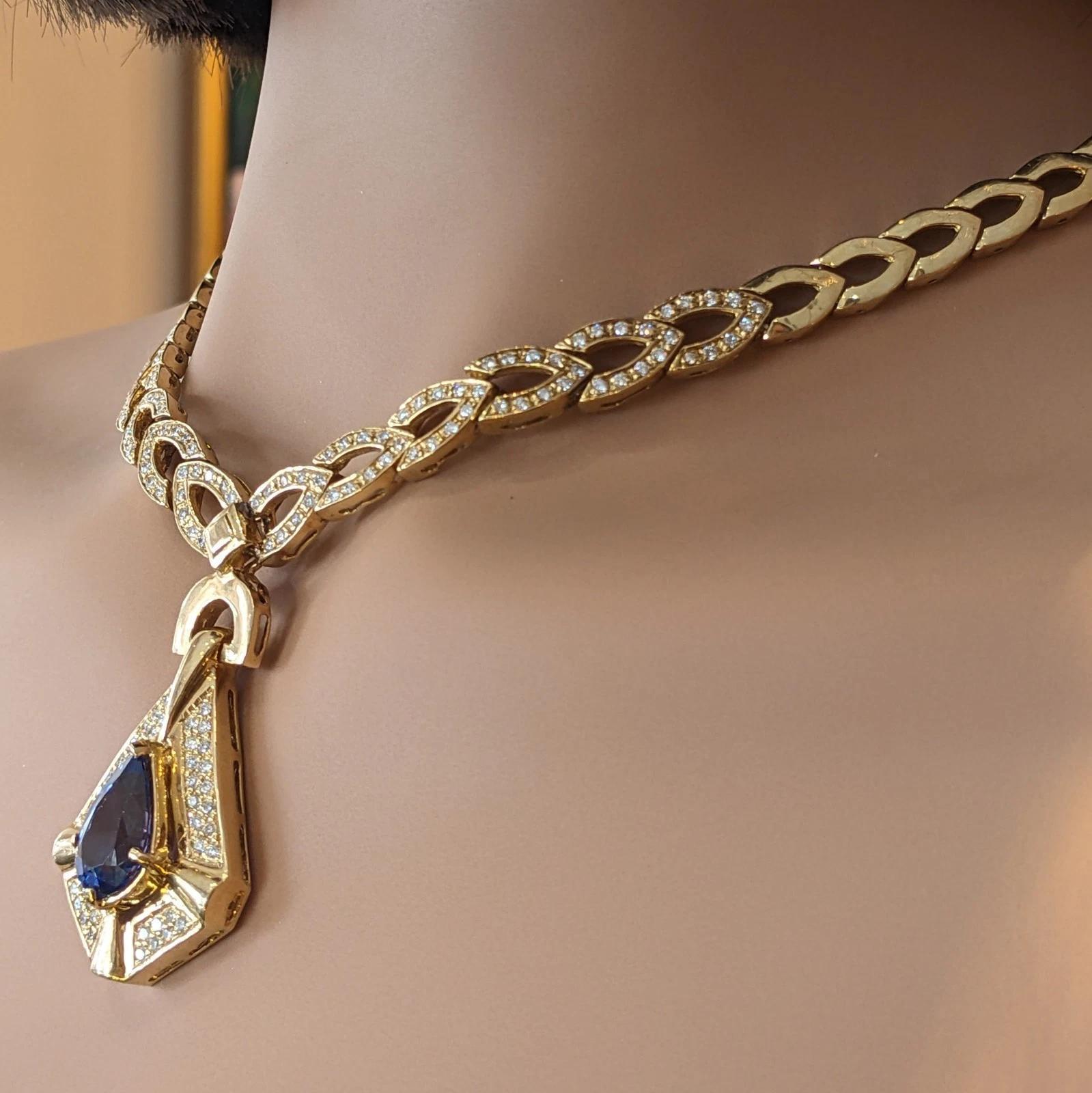 Tanzanite and Diamond Pendant Necklace in 18k Yellow Gold

Tanzanite and Diamond Necklace features a Pear shaped Natural Tanzanite, weighing approximately 5.75 carats, set in 18k Yellow Gold Pendant with Pave set Round Brilliant Diamonds; the
