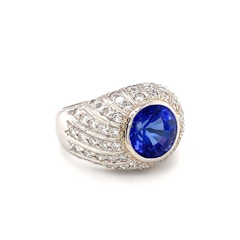 One tanzanite and diamond platinum ring centering one bezel set, round brilliant cut tanzanite weighing 4.50 ct. Enhanced by 66 round brilliant cut diamonds totaling 1.75 ct. Circa 1970s.

Tantalizing, mysterious, shimmering.

Additional