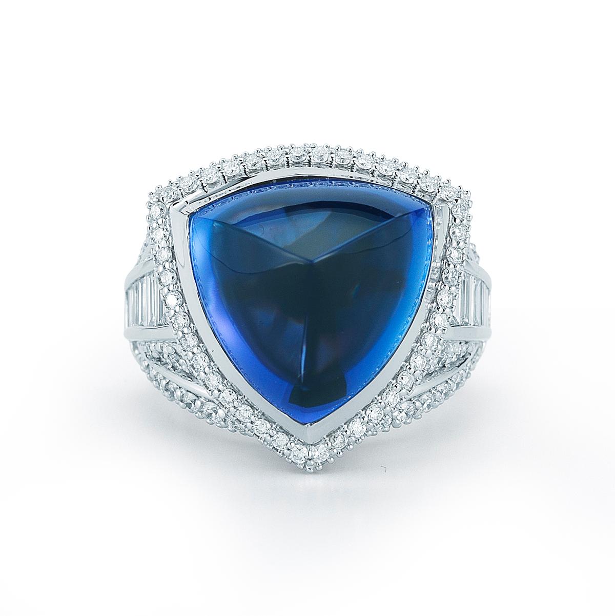 TANZANITE TRILLION CABOCHON RING BY RAYAZTAKAT
A marvelous Tanzanite trillion ring with diamond baguette accents.
Item:	# 01650
Setting:	18K W
Color Weight:	19.27 ct. of Tanzanite
Diamond Weight:	3.14 ct. of Diamonds