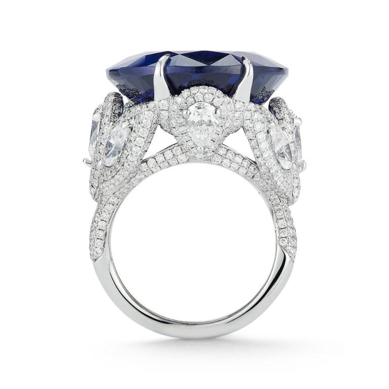 TANZANITE AND DIAMOND RING An extraordinarily rich oval Tanzanite sits atop a diamond encrusted setting featuring pear shapes, marquises, and round diamonds. Item: # 01917 Metal: 18k W Color Weight: 35.03 ct. Diamond Weight: 6.02 ct.
