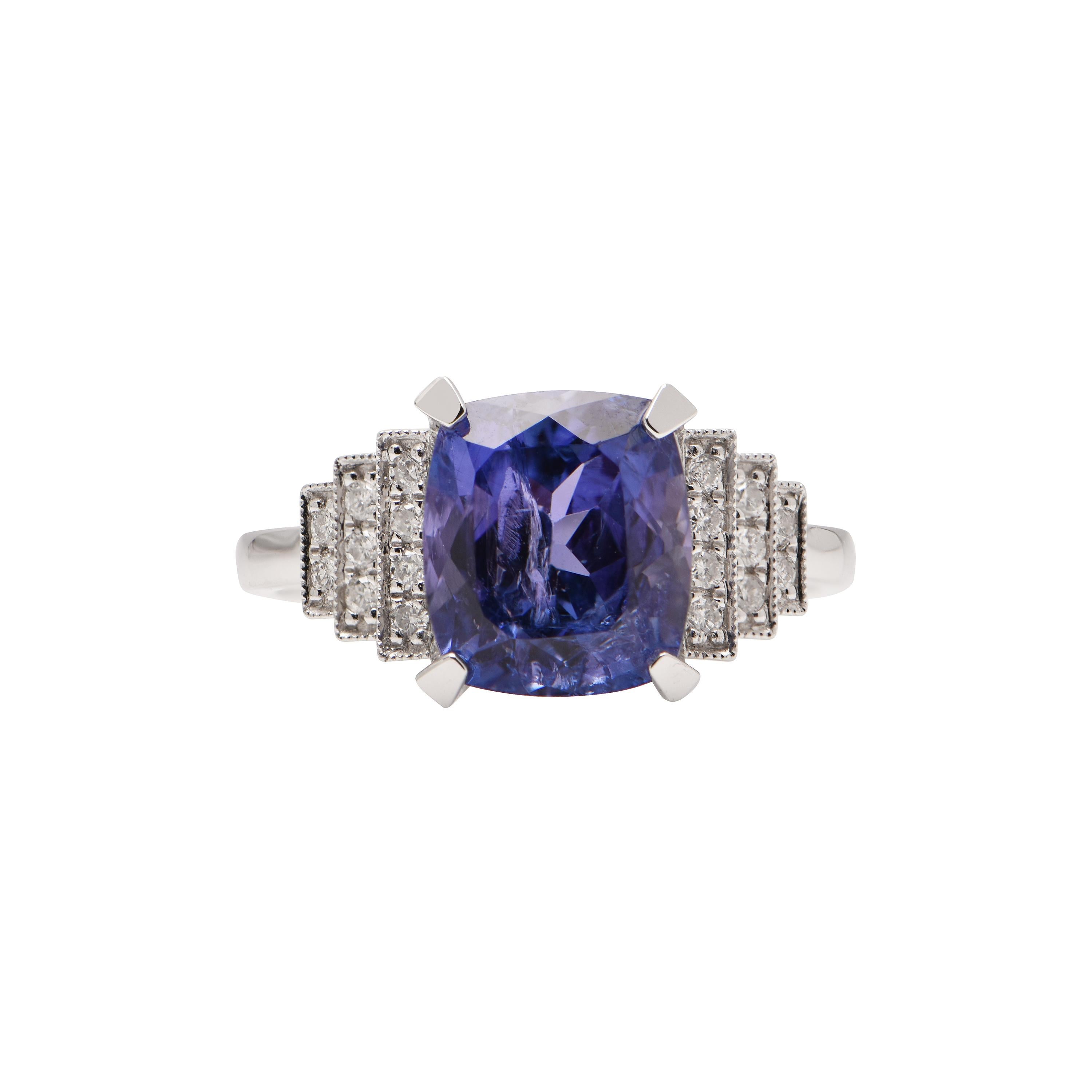 An 18ct White Gold ring showcasing a Tanzanite (3.53ct), and 18 Diamonds totalling 0.15ct. Size M.
