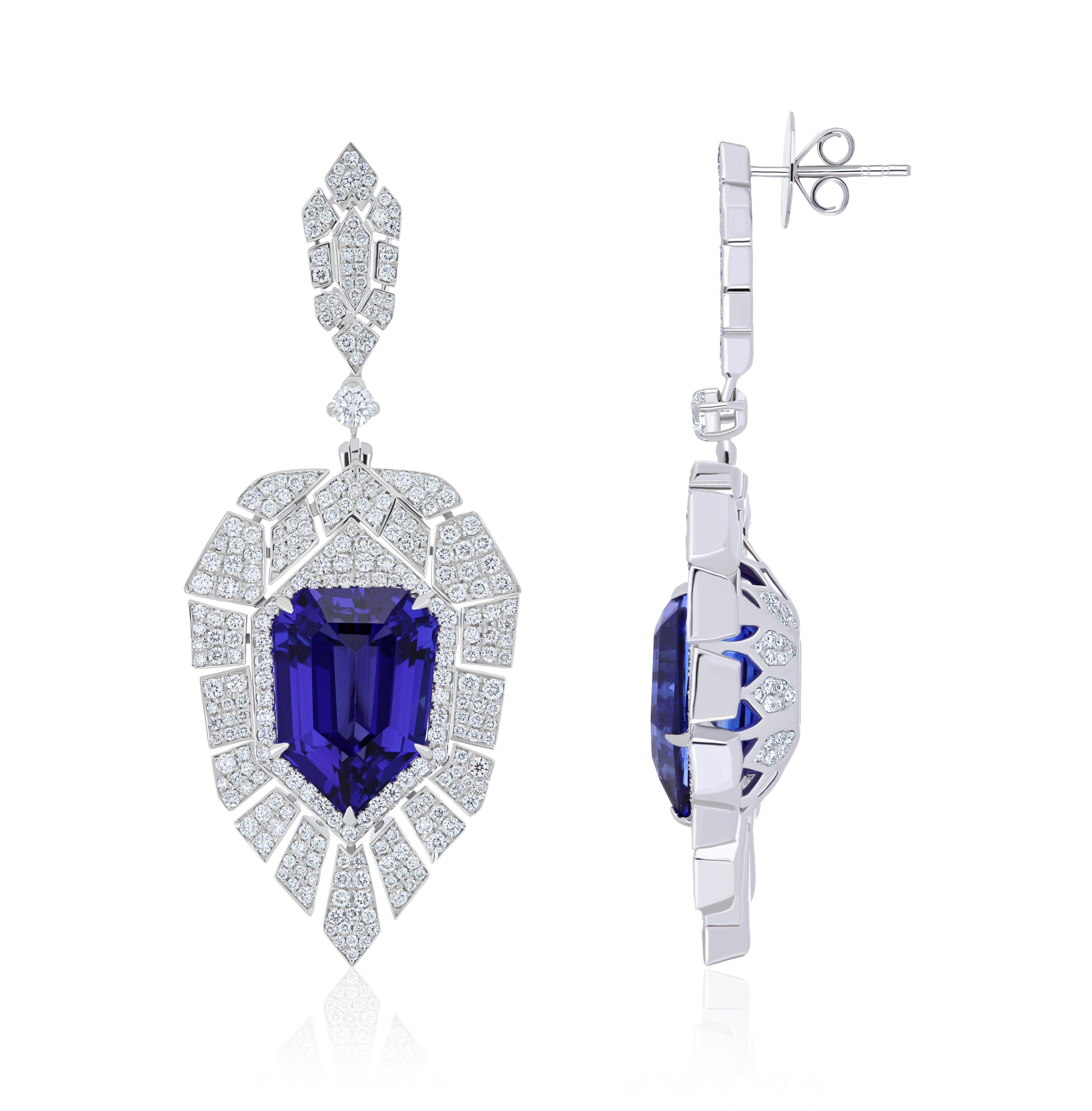 Elegant and Exquisitely detailed White Gold Earring, with 22.07cts. (approx.) Tanzanite cut in Unique Fancy Shield Shape accented with micro pave Diamonds, weighing approx. 3.4 cts. (approx.). total carat weight. Beautifully Hand-Crafted Earring in