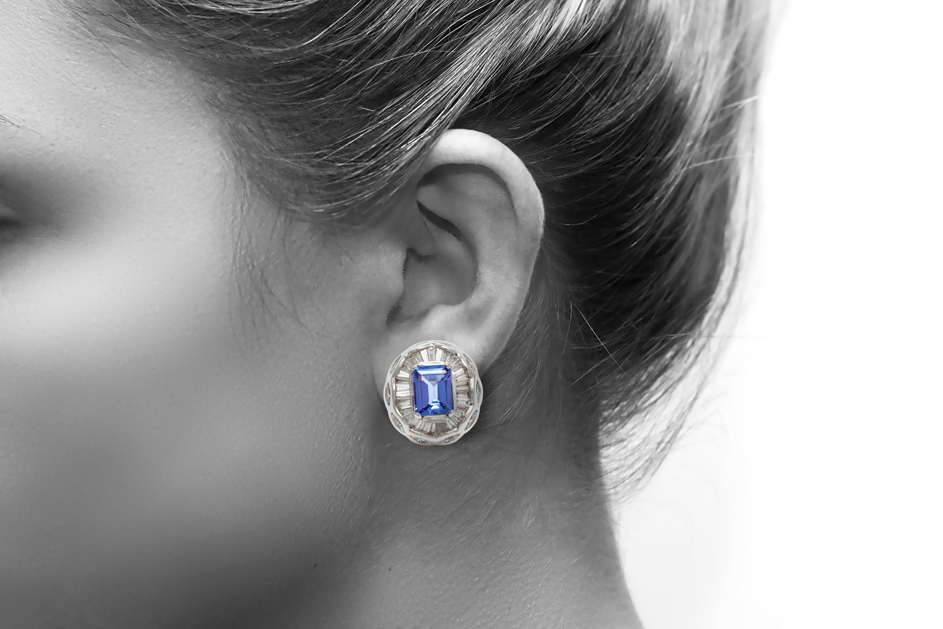 The earrings is finely crafted in 18k white gold with diamonds weighing approximately total of 4.11 carat and center stone tanzanite weighing approximately 4.60 carat.
