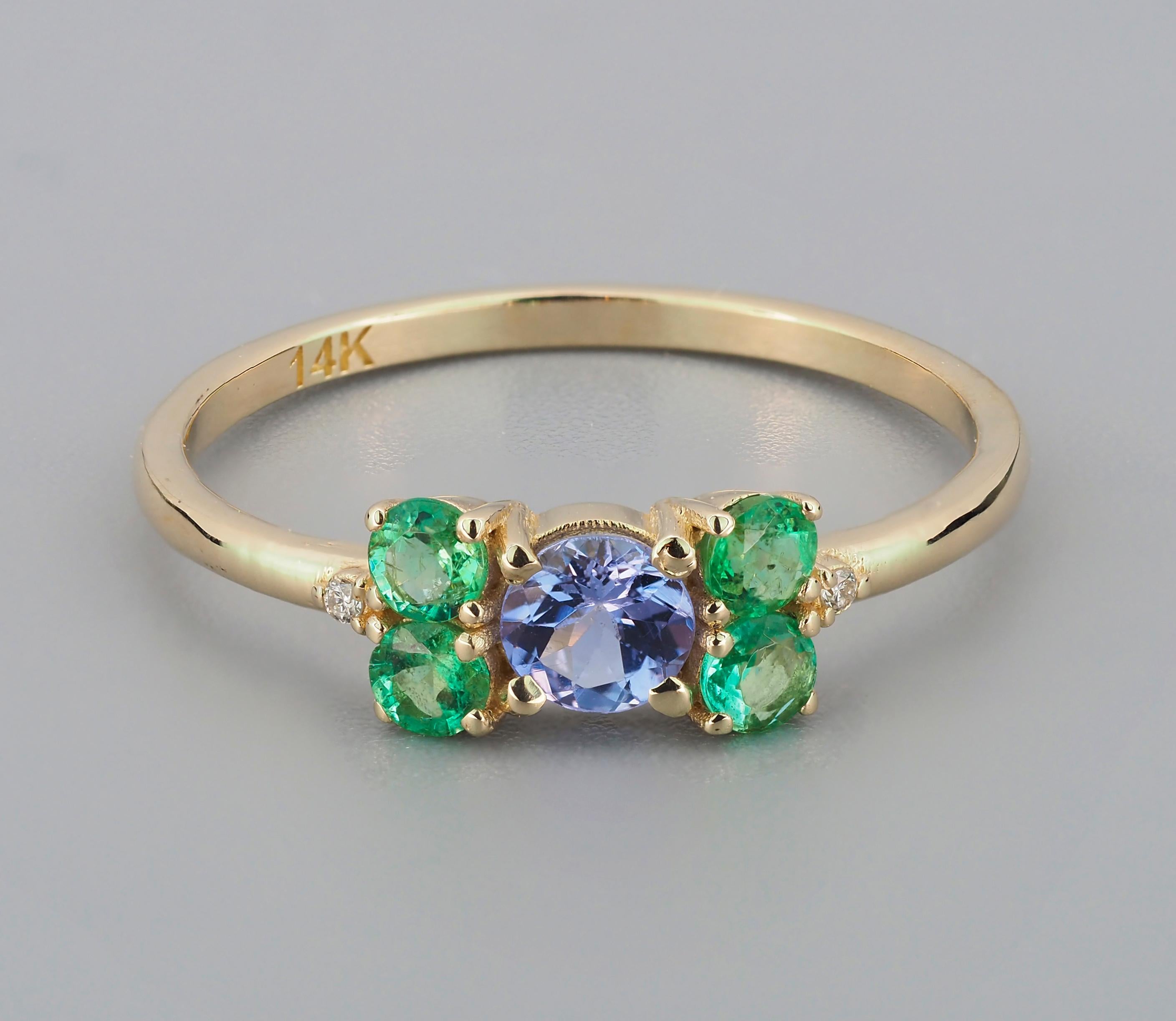 Tanzanite and emeralds 14k gold ring. Round tanzanite gold ring. Tanzanite gold ring. 

Metal: 14k solid gold.
Weight: 1.8 (depends from size).
Set with tanzanite, color - light blue
round cut, aprox 0.45 ct
Clarity: Transparent with