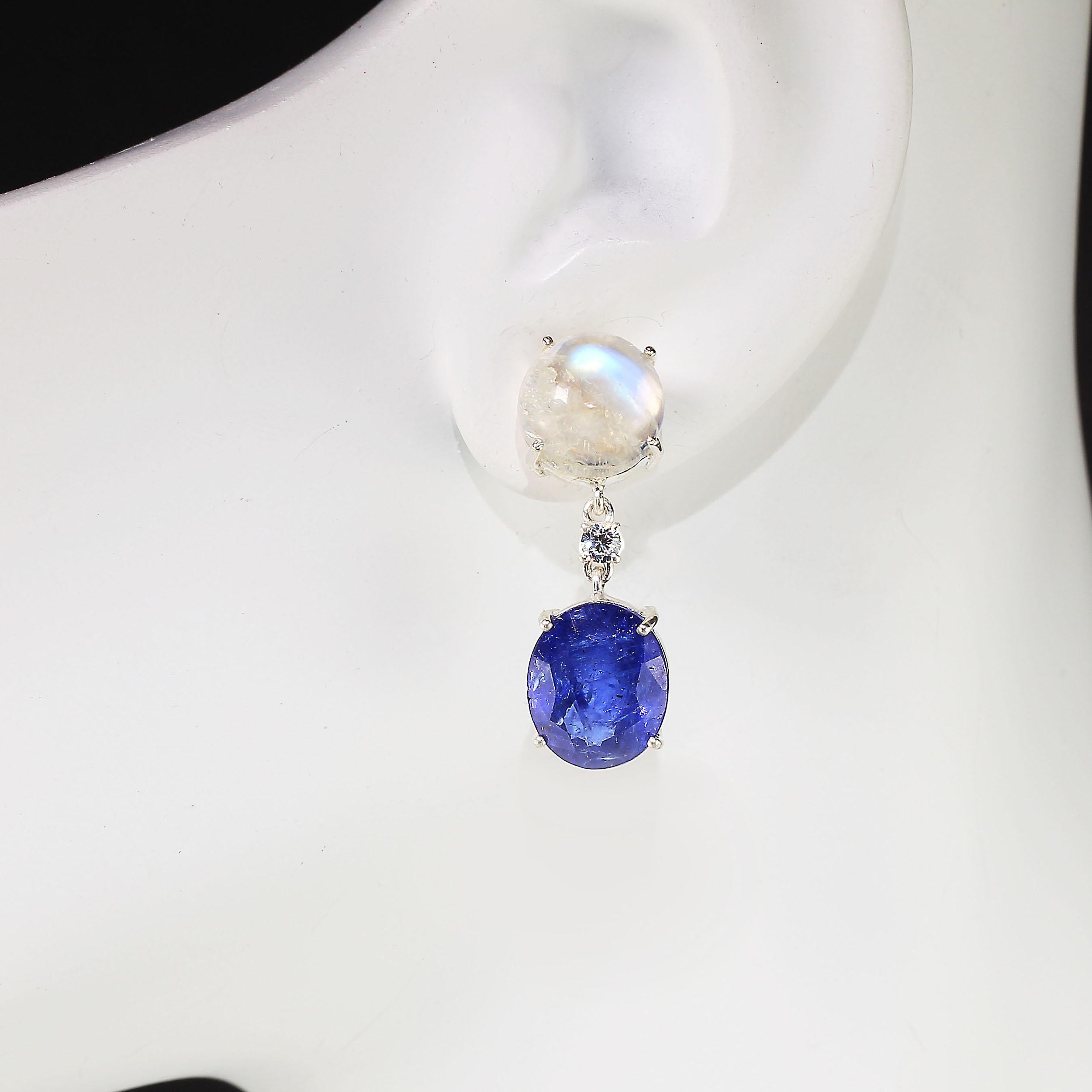 Sophisticated earrings featuring oval Tanzanites swinging from round dreamy white Moonstones.  At just over an inch in length you will love these fun loving eye popping earrings.  The blue Tanzanites swing and dance from tiny sparkling real Zircons