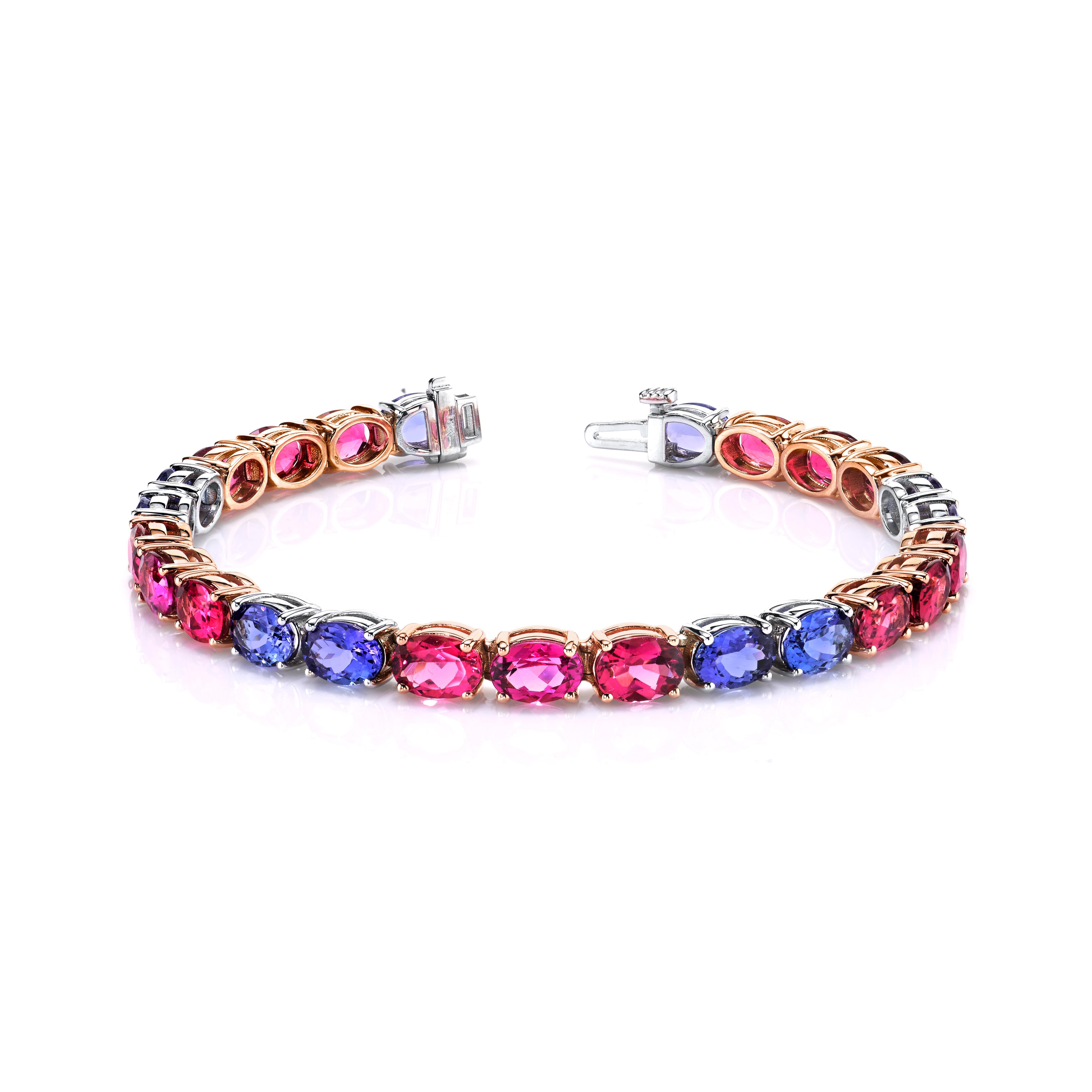This one-of-a-kind bracelet features fine tanzanites and rich rubellite tourmalines set in 18k white and rose gold. While the line of stunning gems is laid out in classic tennis bracelet style, we have set the purple blue tanzanites and deep rosy