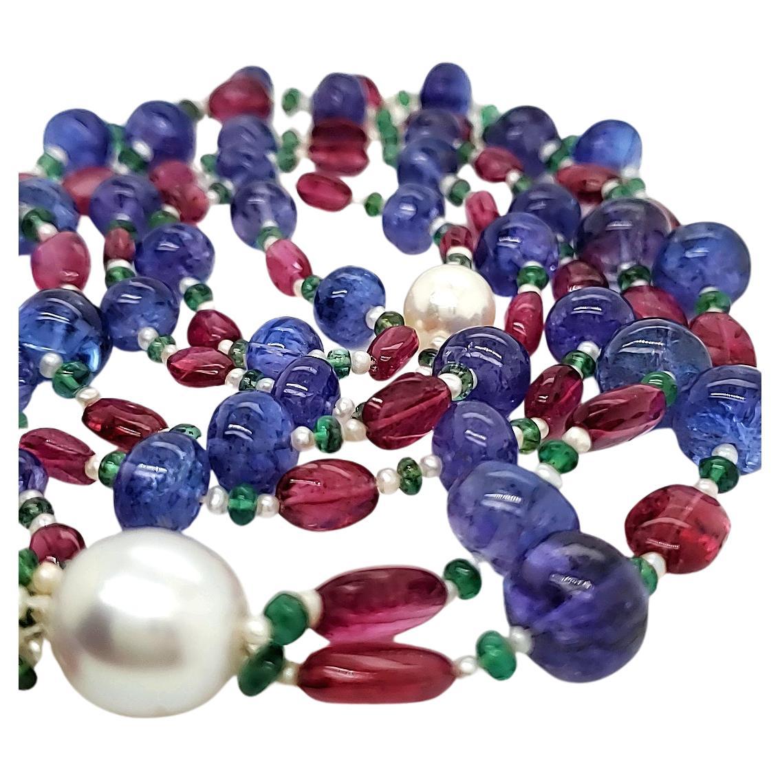 This luxurious piece showcases 340.00 cts of tanzanite and ruby beads, harmoniously intertwined with delicate small pearls and a striking large pearl at the center. 

The design culminates in a chic tassel.

Sourced from the vibrant lands of