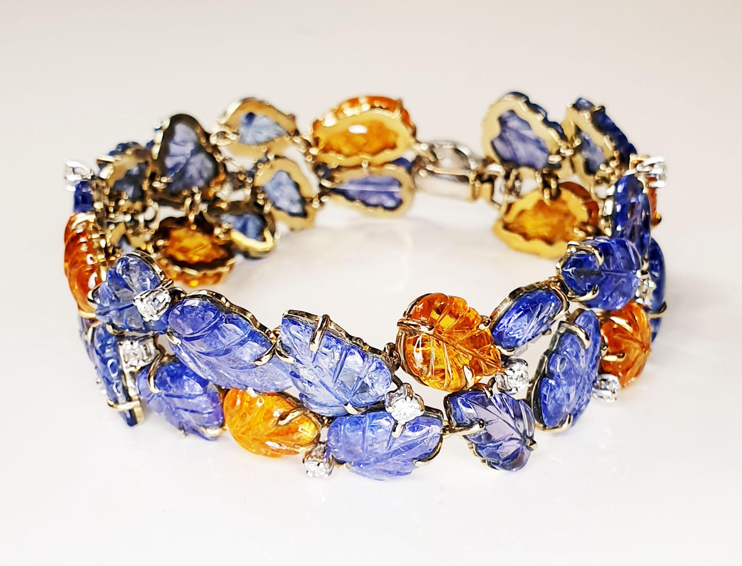 Diamonds Tanzanite and spessartite garnet carved leafs clutch bracelet in 18k yellow and white gold
Irama Pradera is a Young designer from Spain that searches always for the best gems and combines classic with contemporary mounting and styles. 
This