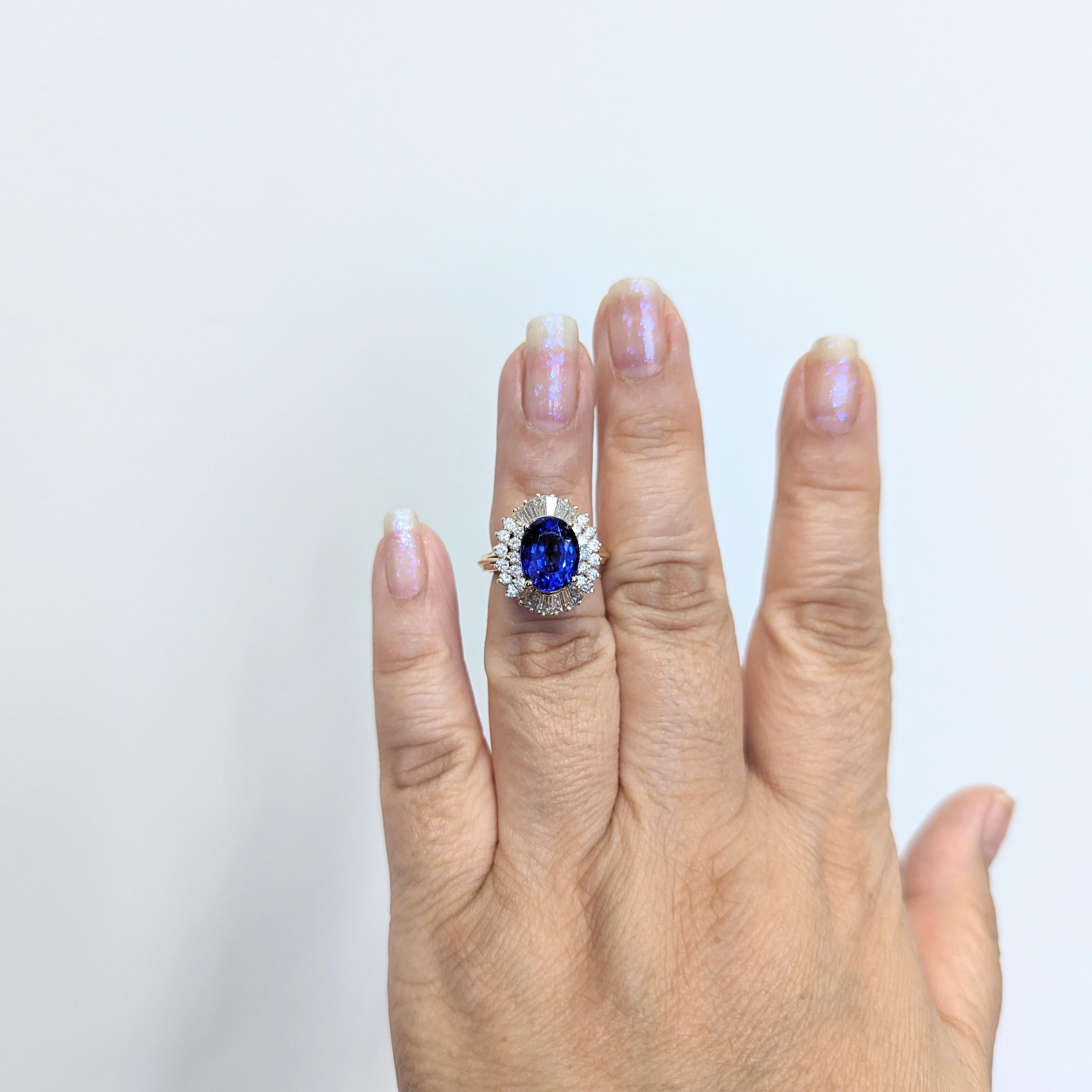 Beautiful 3.45 ct. tanzanite oval with good quality white diamond rounds and baguettes.  Handmade in 14k yellow gold.  Ring size 5.25.