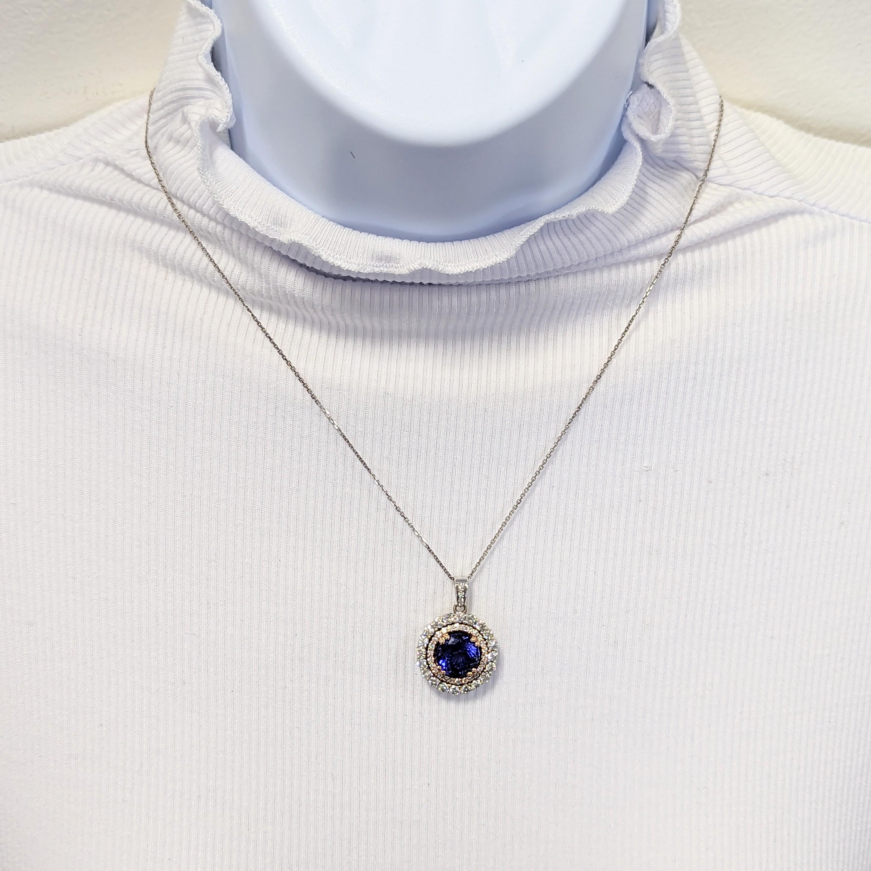 Beautiful 5.98 ct. tanzanite round with 1.60 ct. white diamond rounds.  Handmade in 14k white and rose gold.  Length is 18